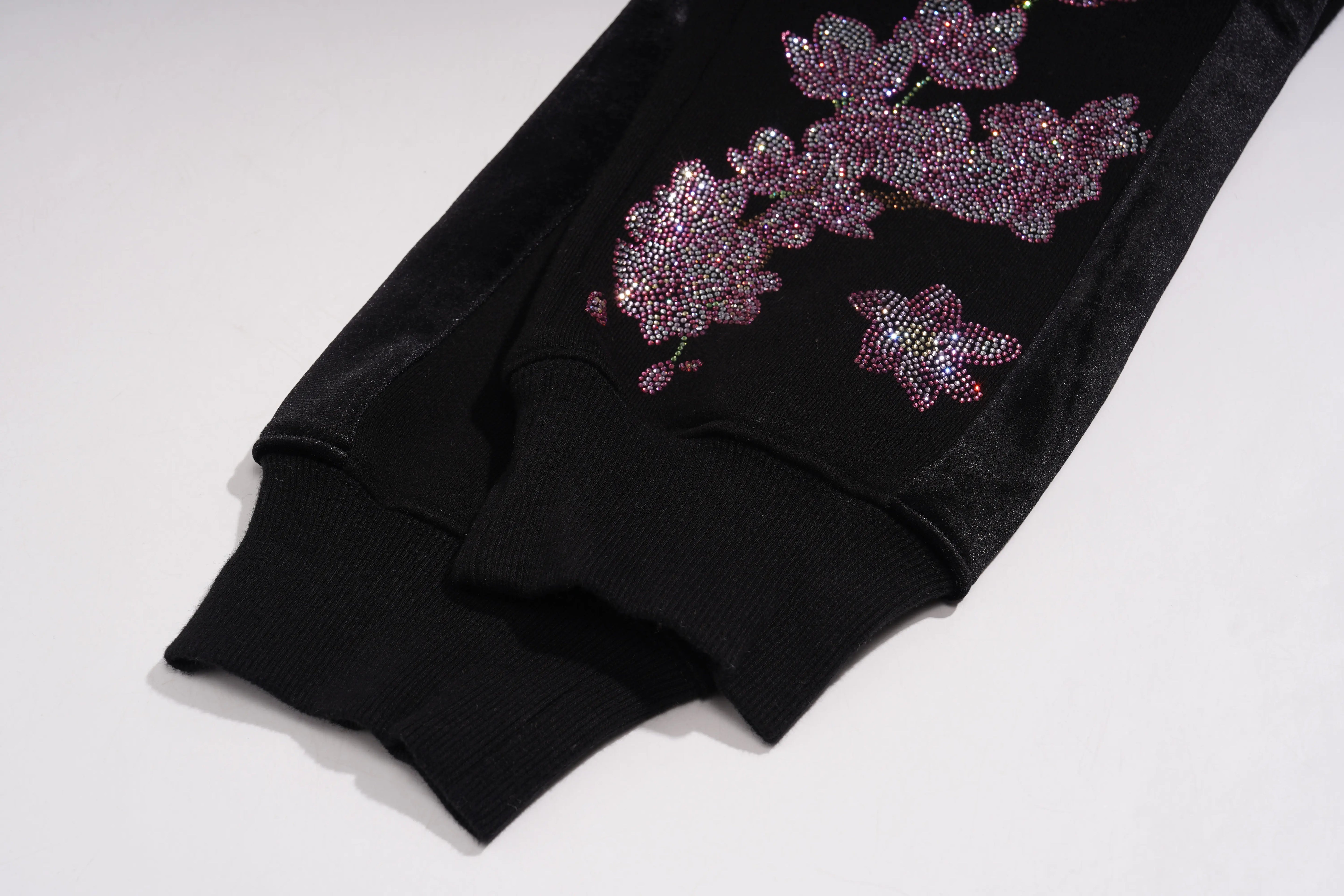 Black garment with floral embellishments on a white background, TCH Pink Blossom Rhinestone Jogger Pants