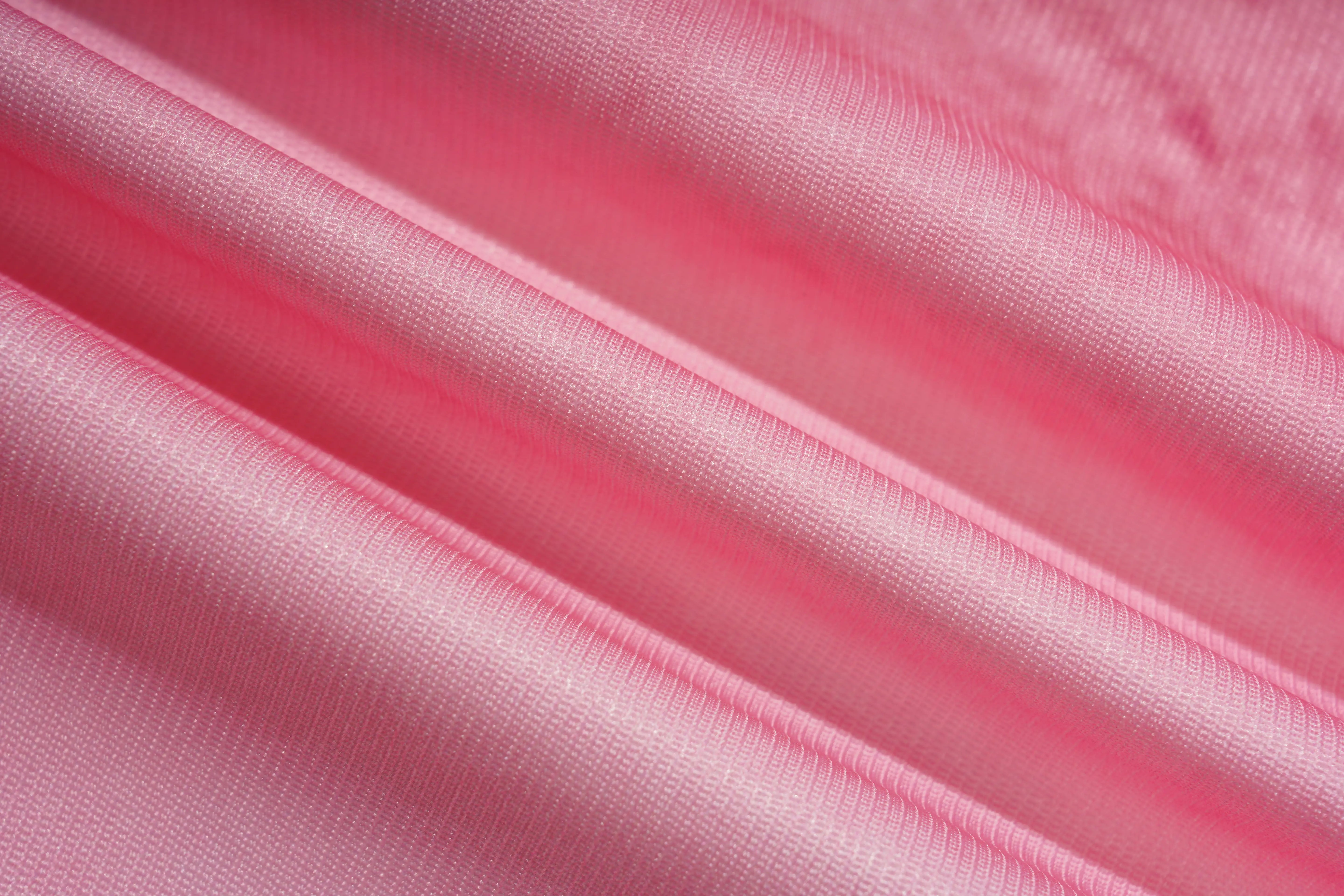 A close-up of draped pink fabric with a smooth, slightly lustrous texture and soft folds. TCH Pink Butterfly Rhinestone Star Wide Leg Jeans