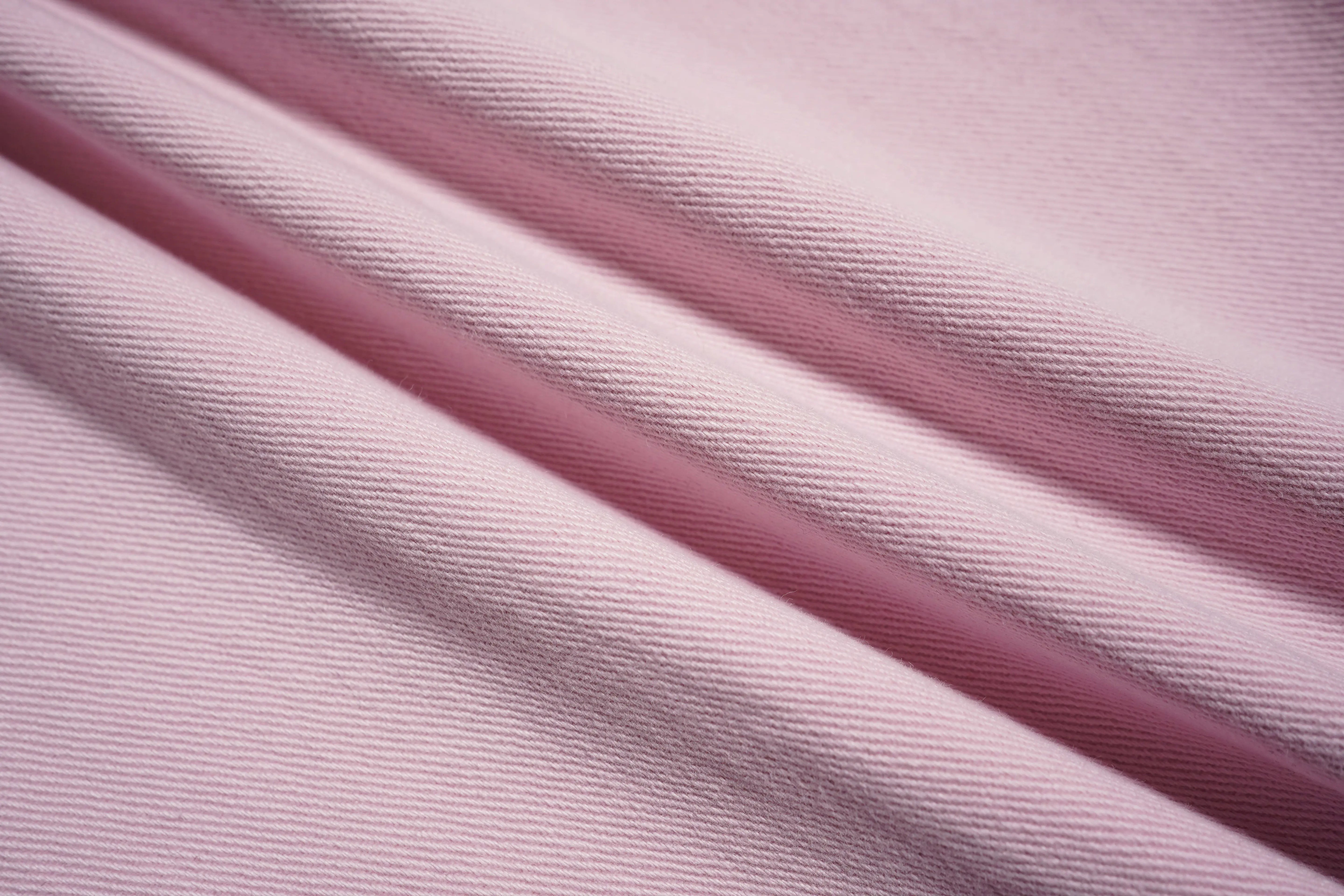 Close-up of pink and purple fabric with a textured pattern, TCH Pink Rhinestone Gradient Denim Jeans with Logo Detail