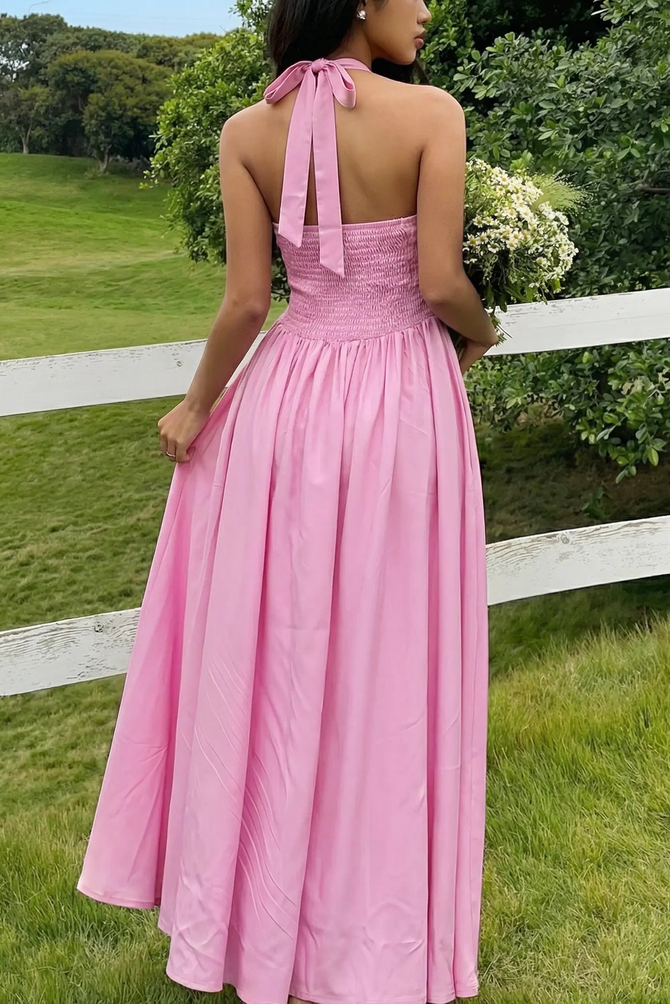 Woman in a pink dress standing in a grassy field with a white fence. TCH Pink Rhinestone Teddy Laundry Story Dress