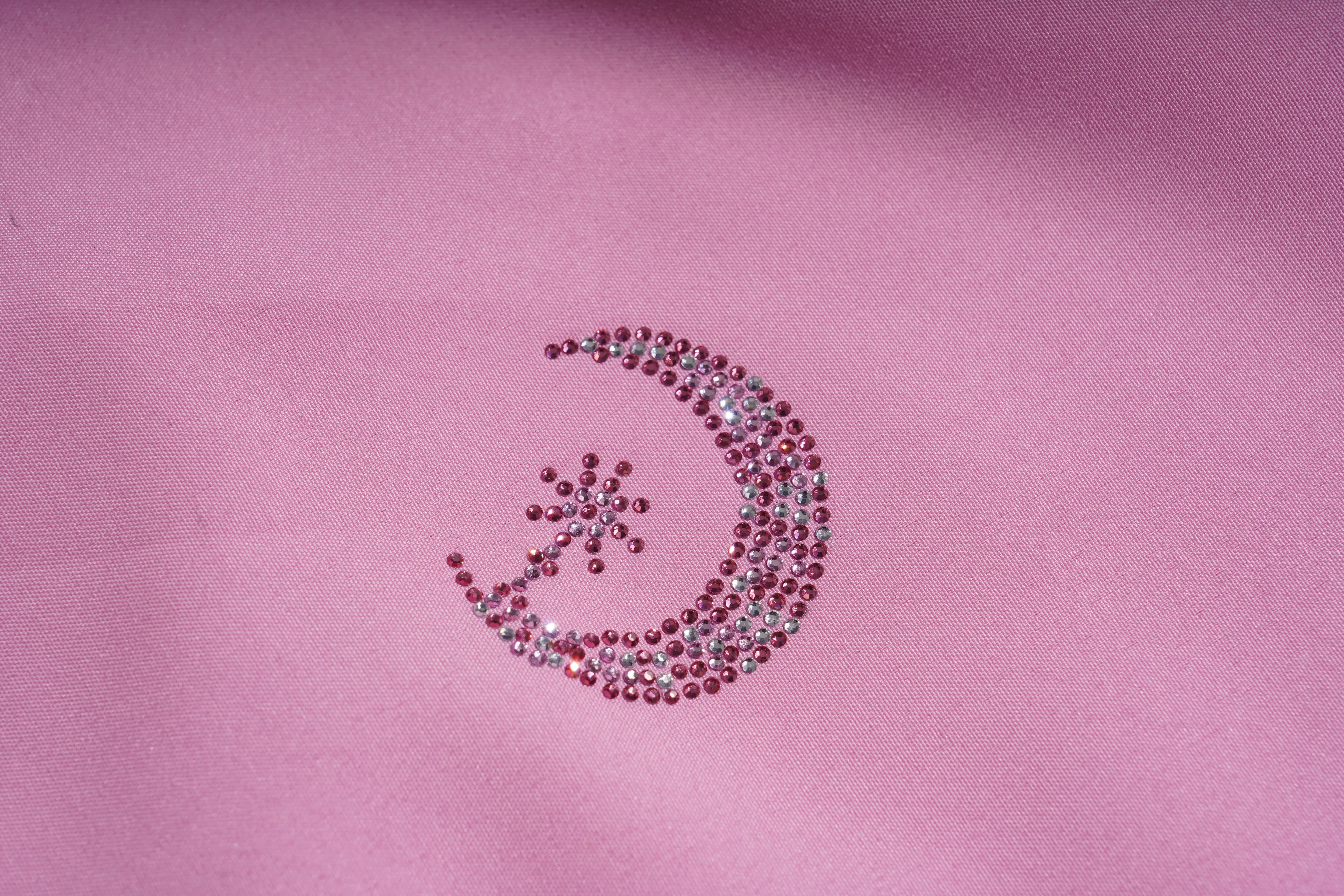 Decorative crescent moon and star design made of small beads on a pink fabric background, TCH Pink Rhinestone Teddy Laundry Story Dress