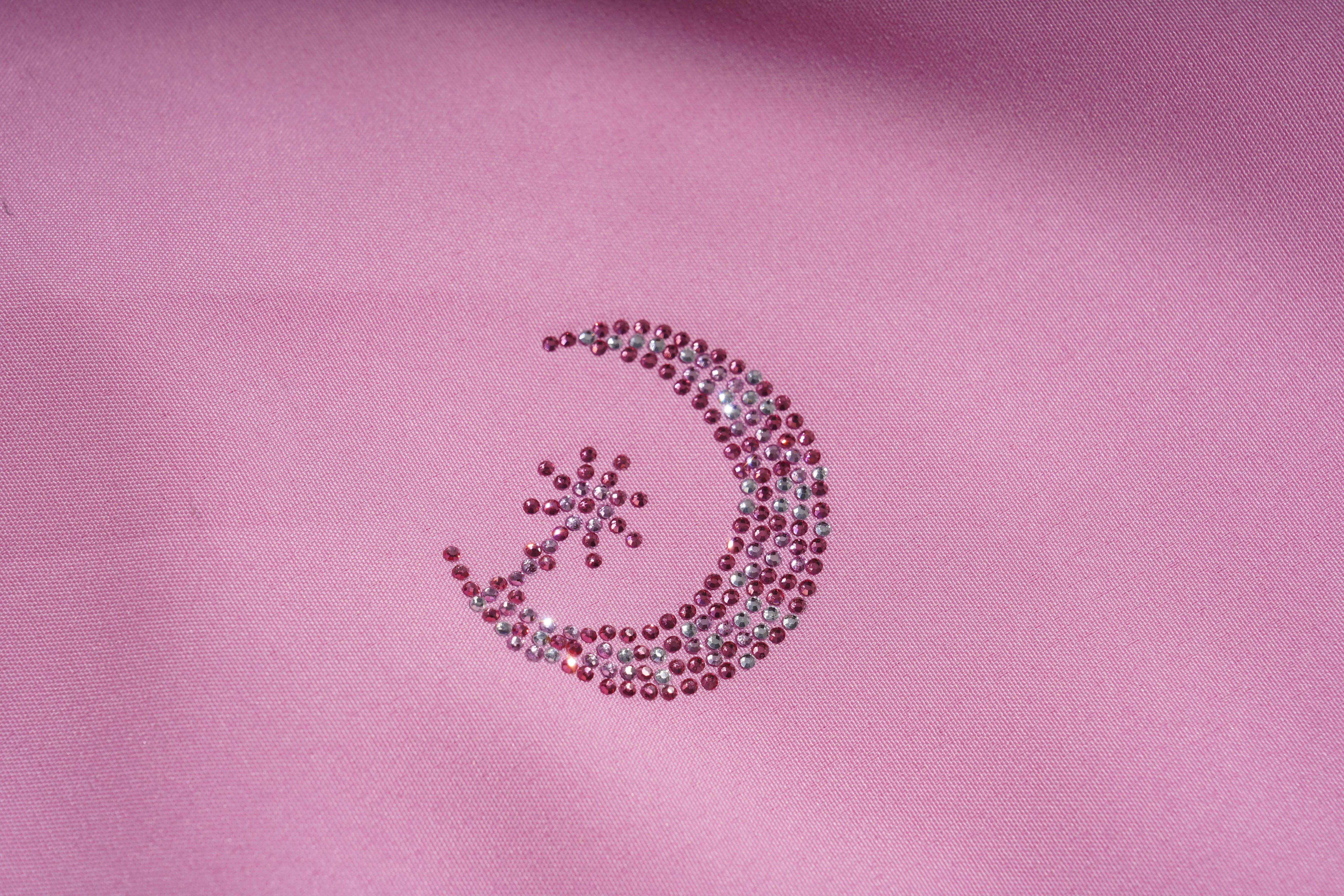 Decorative crescent moon and star design made of pink rhinestones on a pink fabric background, TCH Pink Rhinestone Teddy Laundry Story Dress