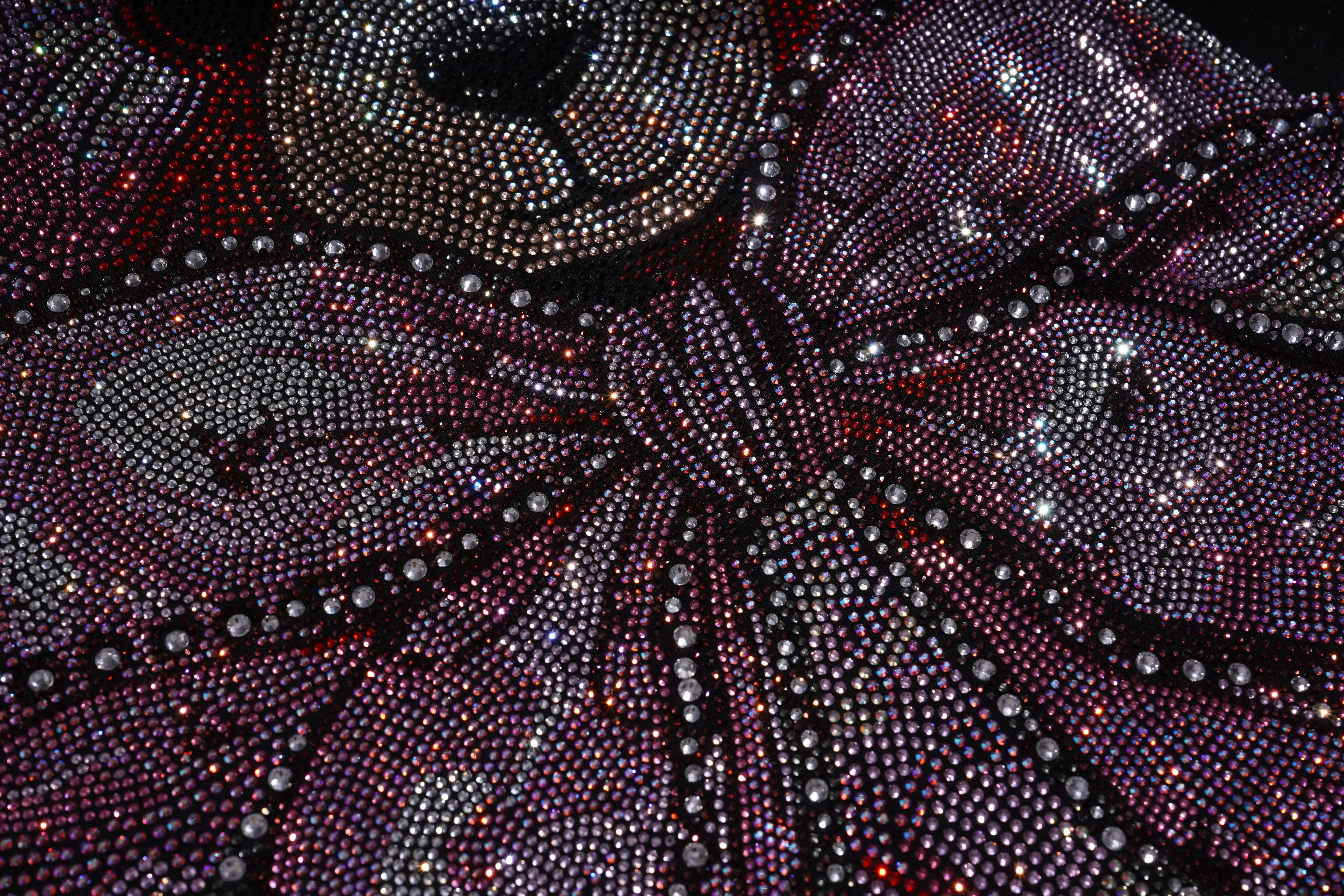 Close-up of a decorative fabric with intricate patterns and embellishments. TCH Pink Teddy Bear Rhinestone T-Shirt