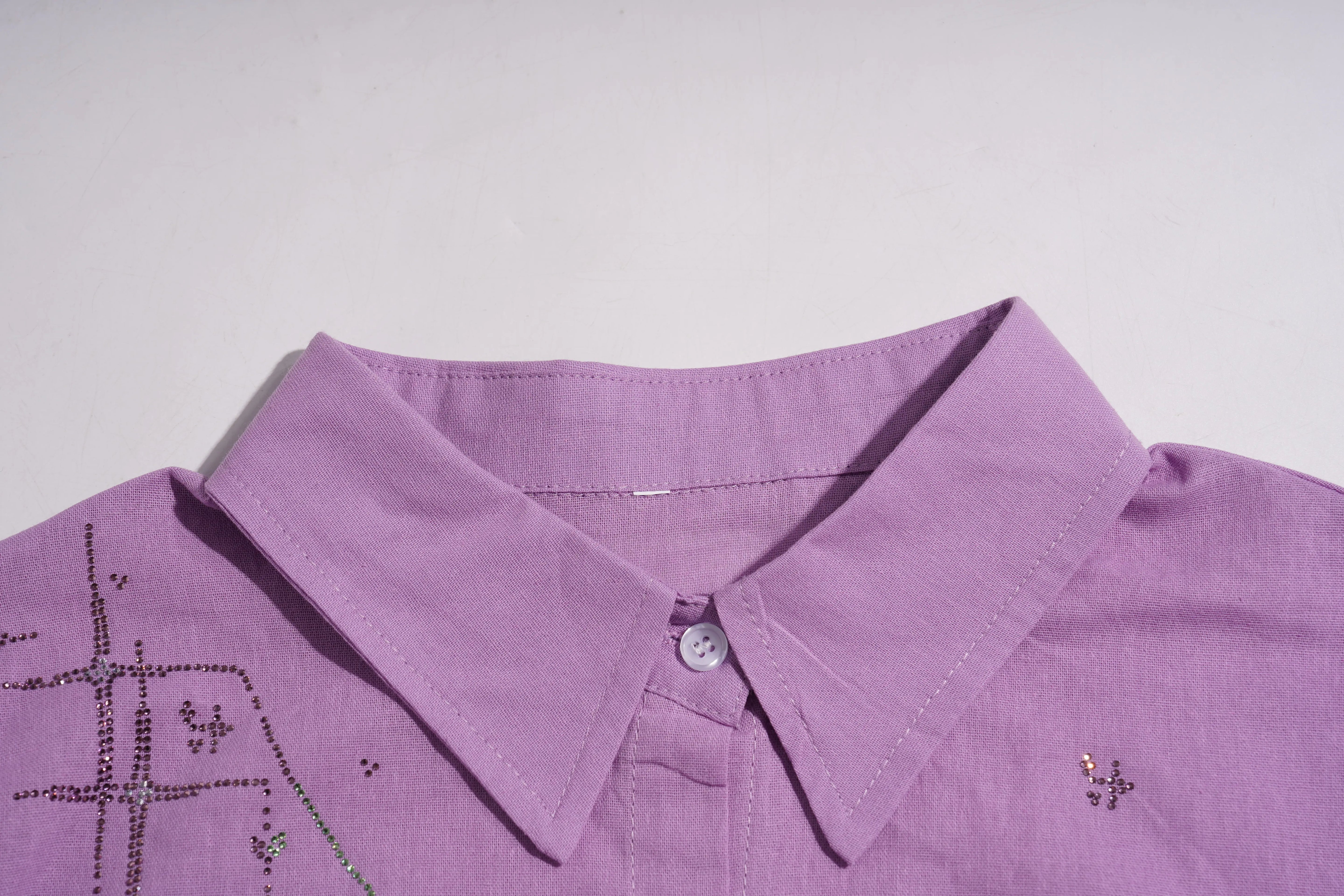 Close-up of a purple shirt collar with decorative elements on a light gray background, TCH Purple Rhinestone Butterfly Set