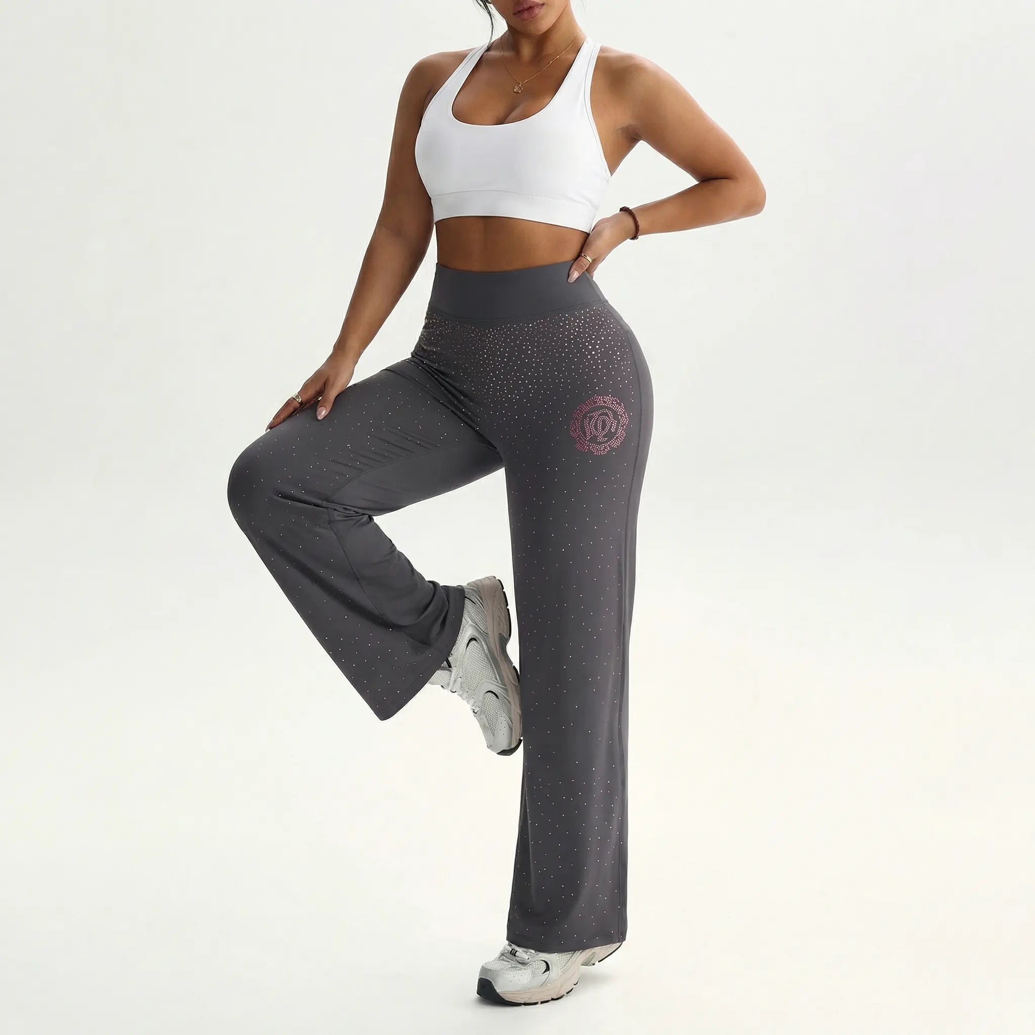 Person wearing gray leggings with a logo and a white sports bra on a white background, TCH Purple Rhinestone Gradient Sweatpants