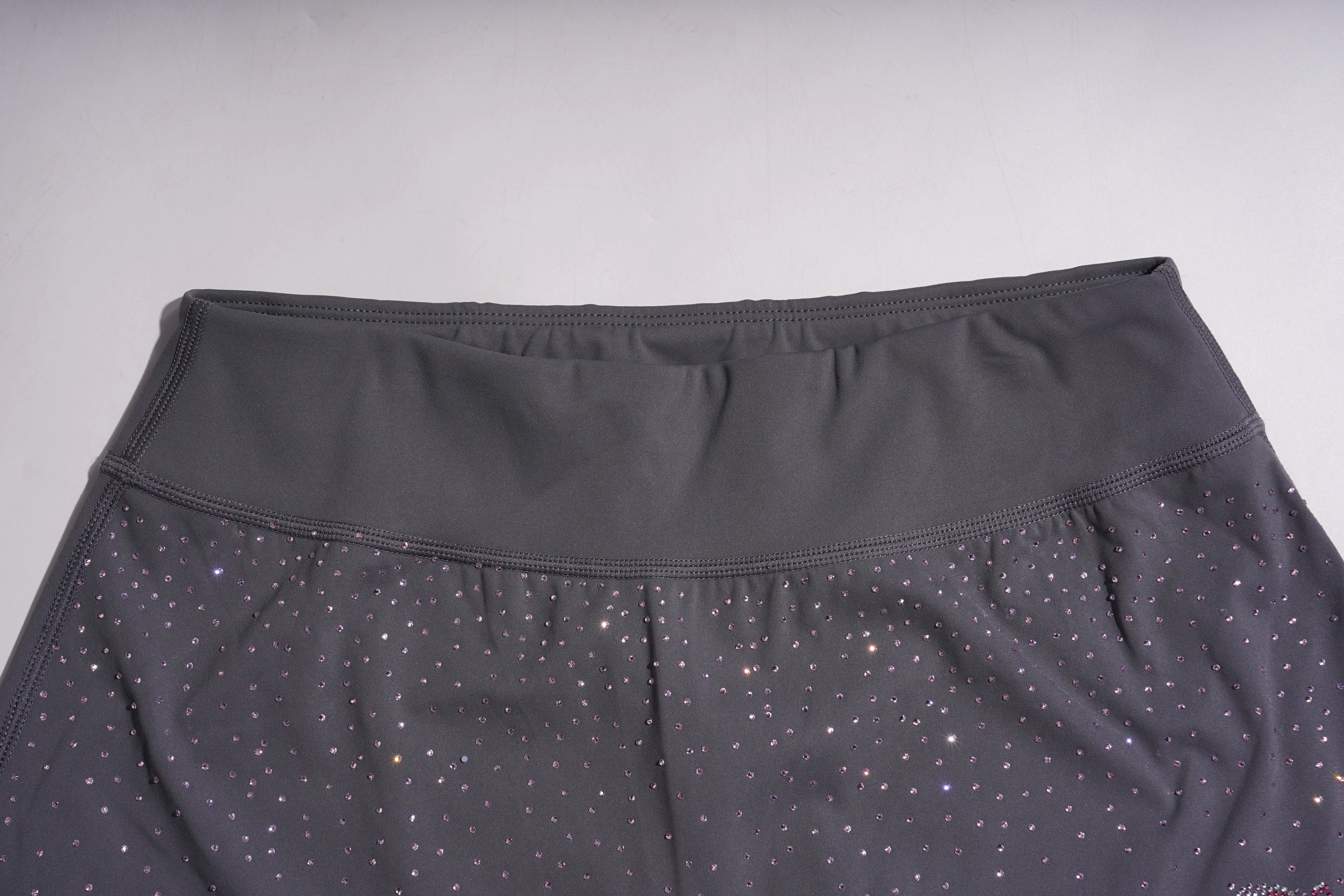 Dark gray leggings with subtle pattern on a light gray background, TCH Purple Rhinestone Gradient Sweatpants