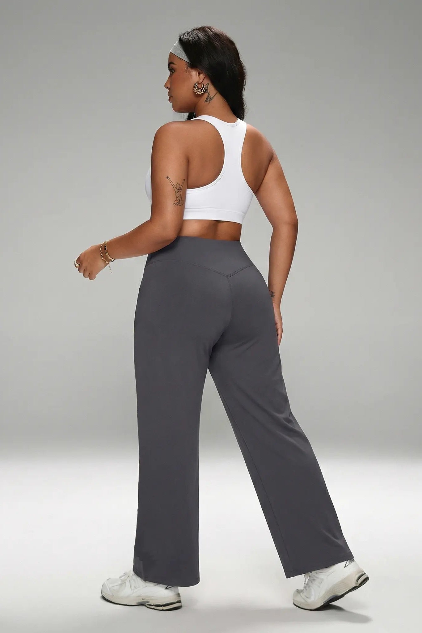 Woman wearing a white sports bra and gray leggings on a gray background, TCH Purple Rhinestone Gradient Sweatpants