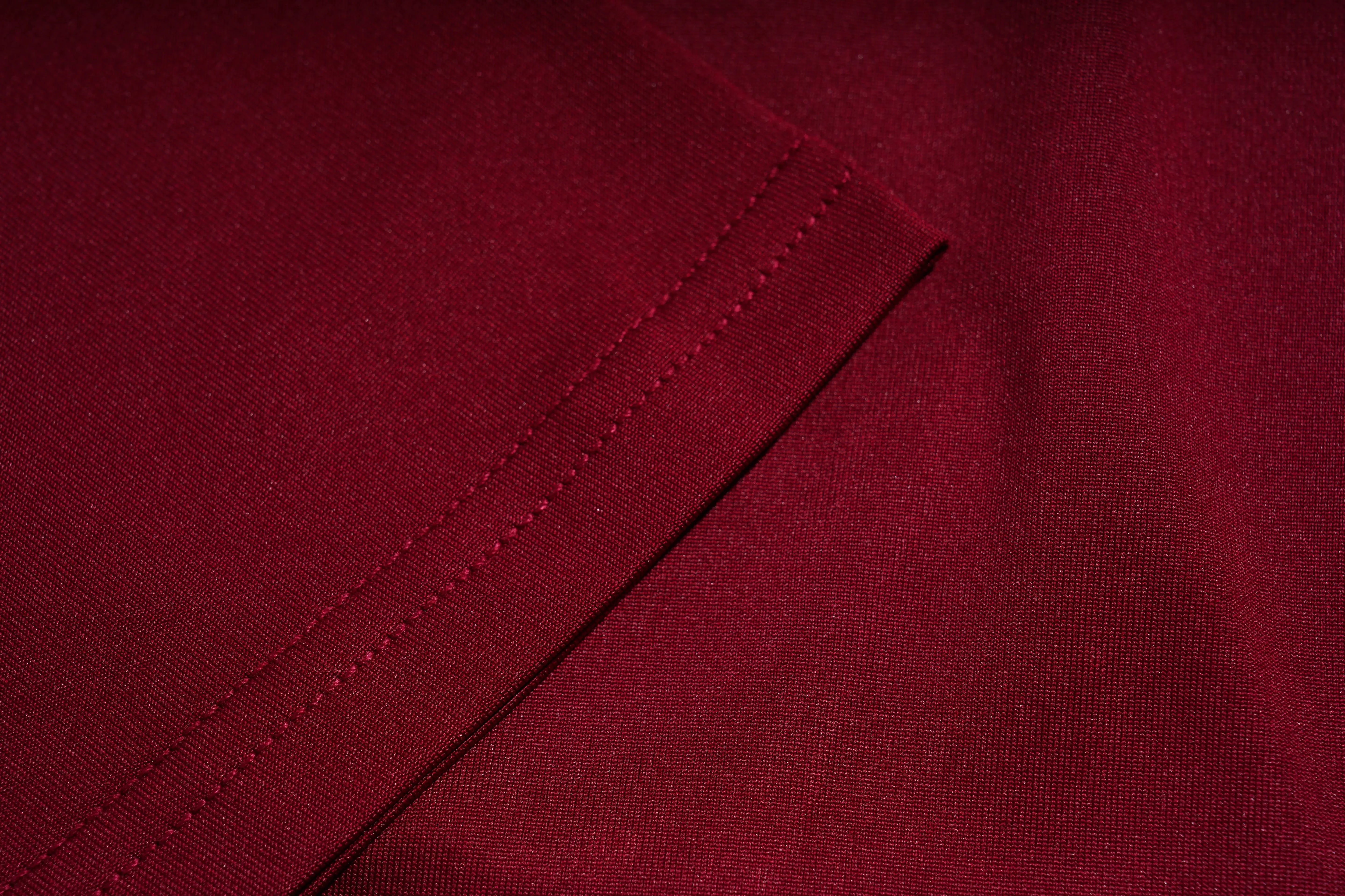 Close-up of a red fabric with stitching detail, TCH Red Lace Trim V-Neck Rhinestone Wing Long Sleeve Top