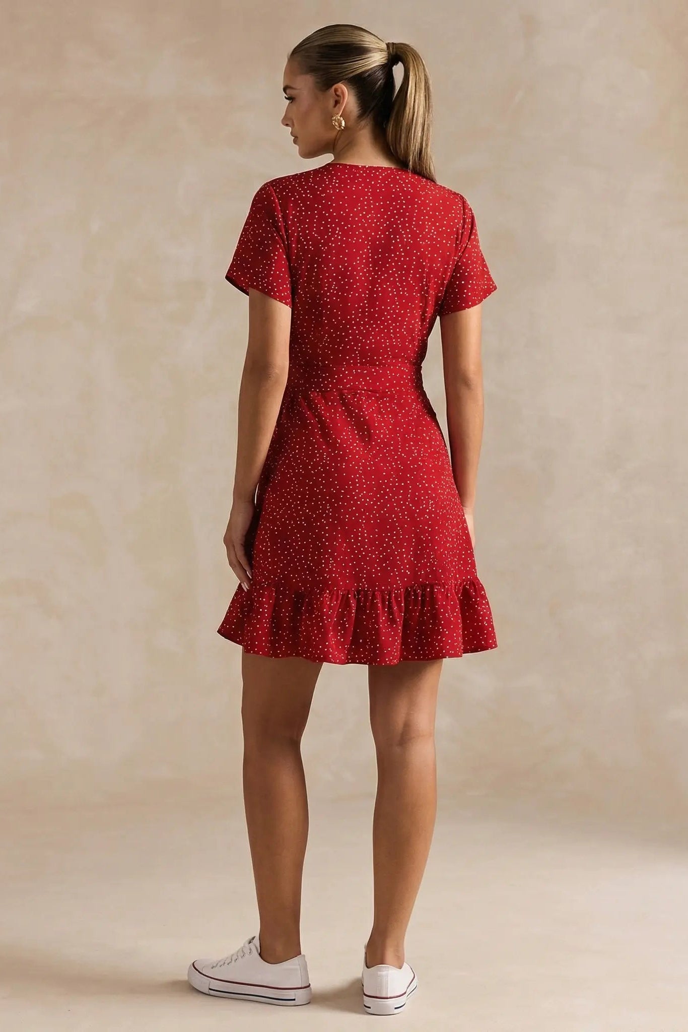 Woman wearing a red dress with a beige background, TCH Red Polka Dot Rhinestone Flower Dress