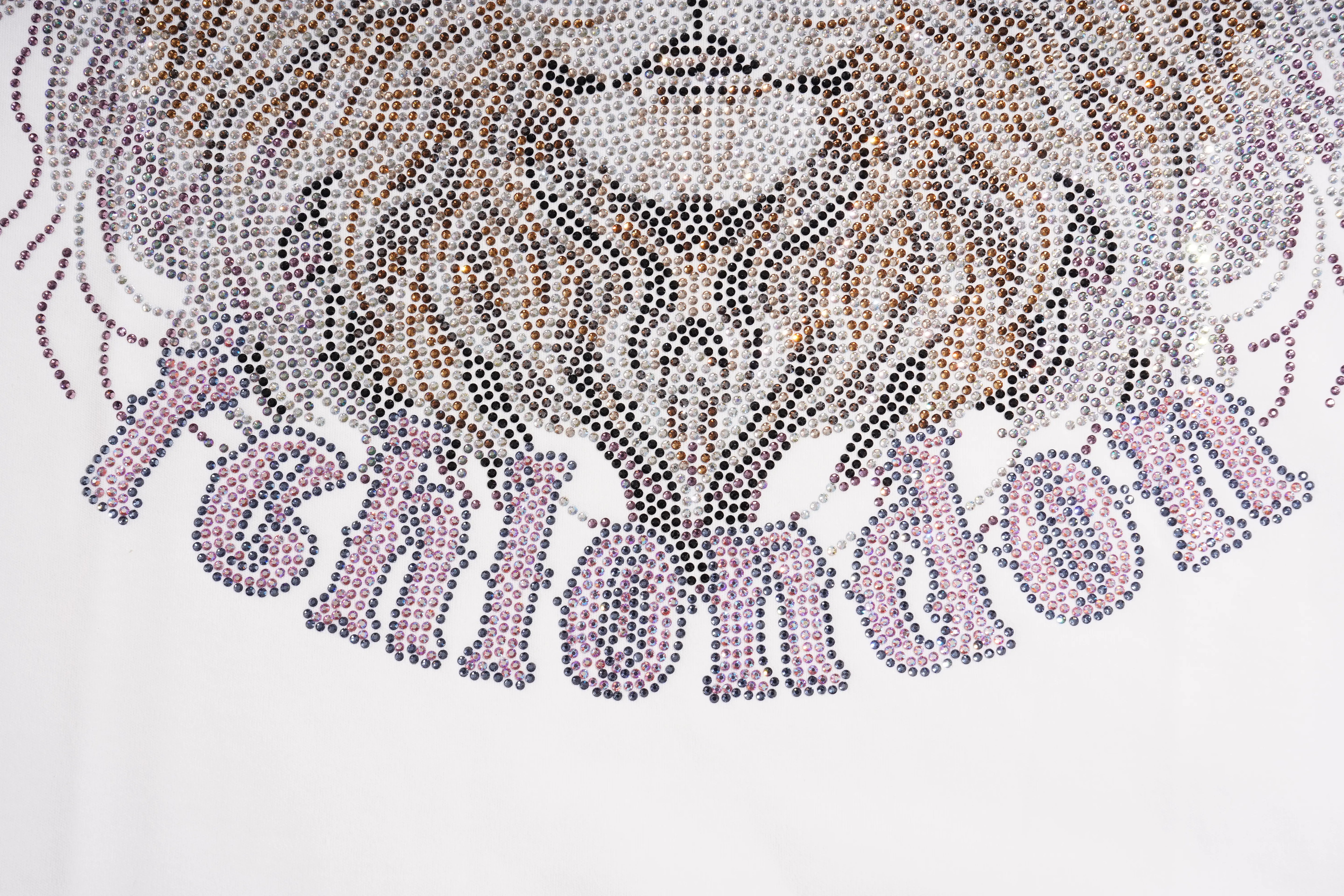 A close-up of a white garment featuring a large lion head and the word 'FCLONDON' embellished with rhinestones in silver, pink, and gold tones. TCH Regal Crown Lion Rhinestone Graphic T-Shirt