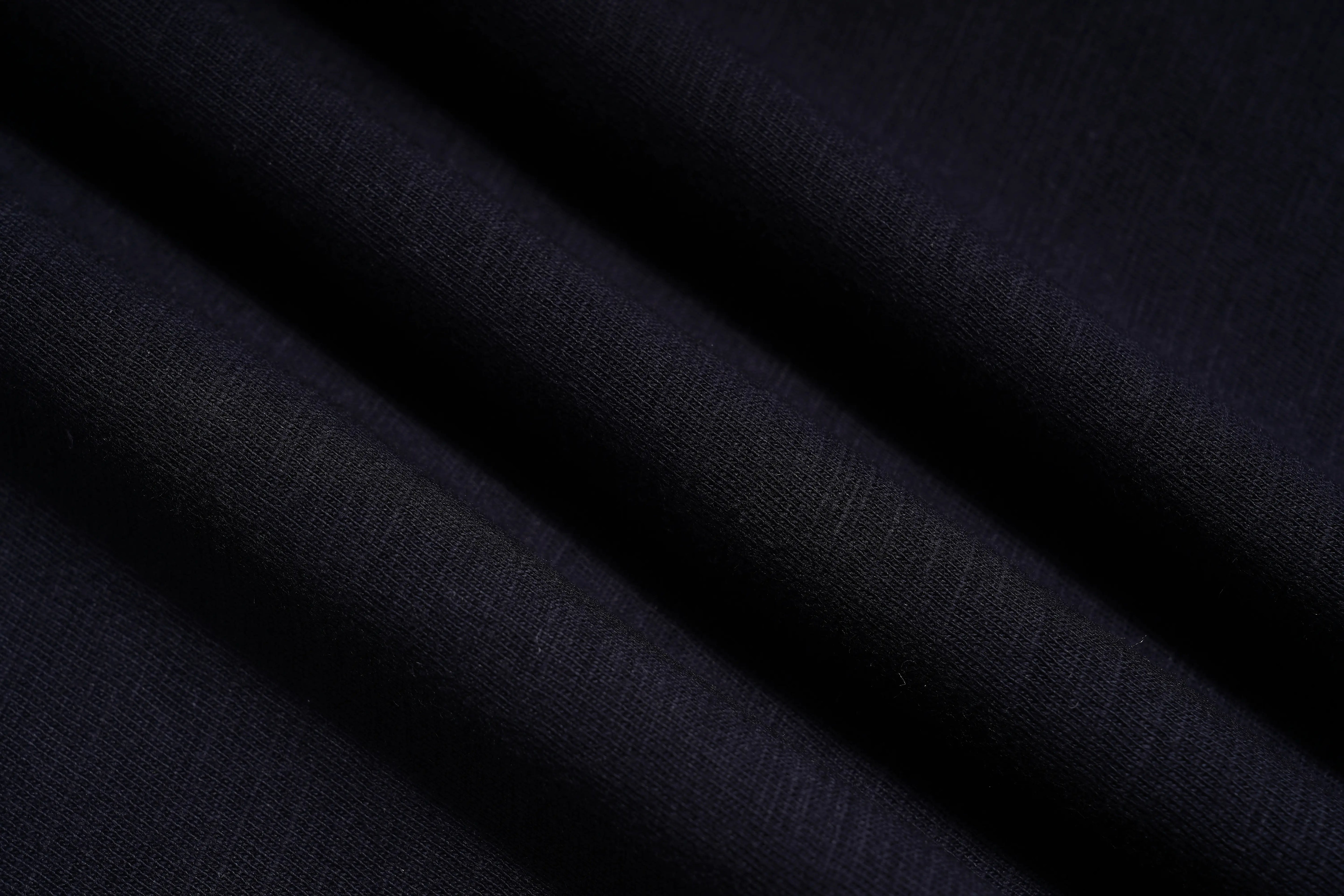 A close-up of dark navy blue fabric with soft diagonal folds showing a fine knit texture. TCH Regal Lion Rhinestone Graphic T-Shirt