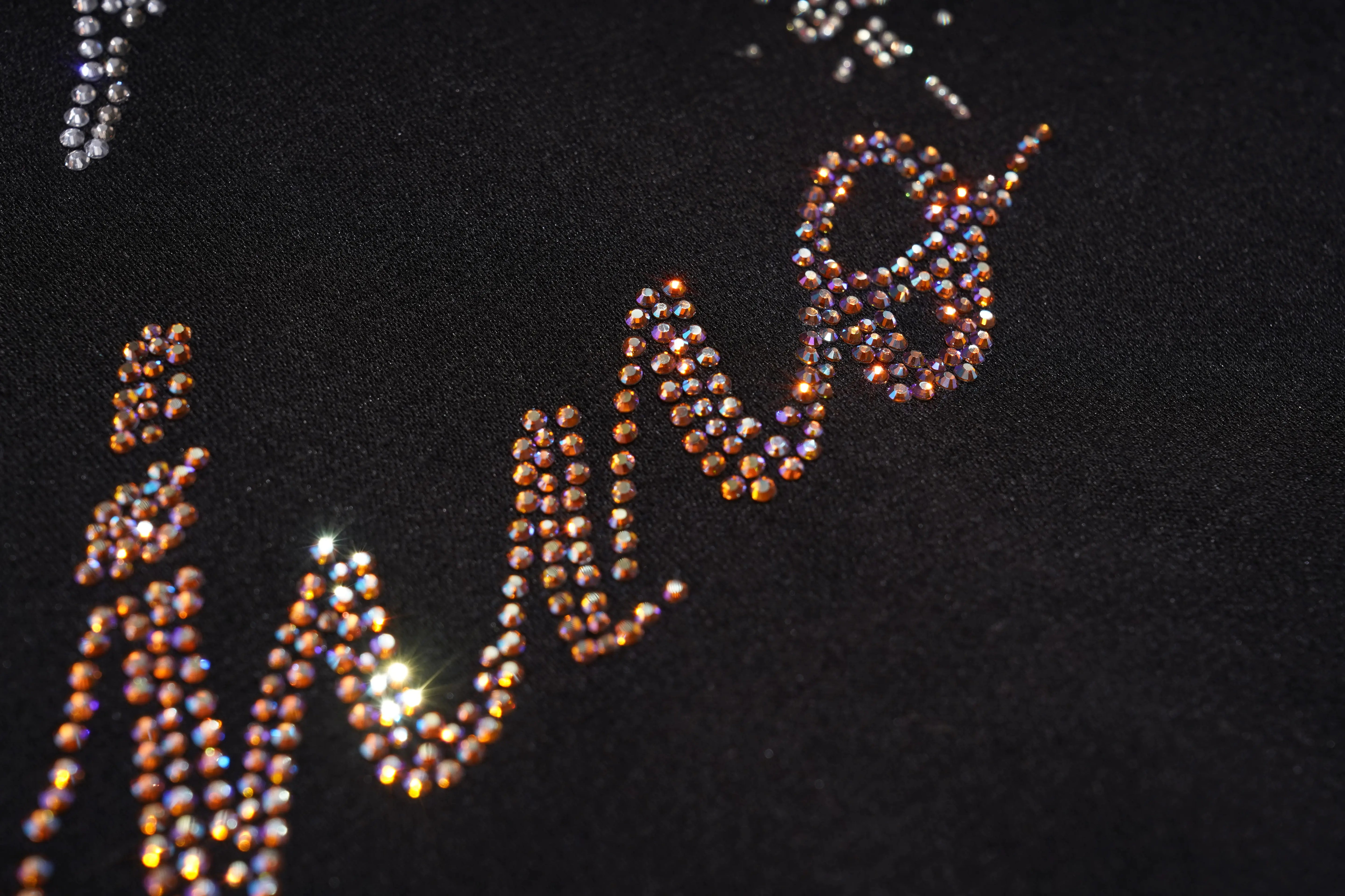 Close-up of 'LIVE' text with rhinestones on a black background, TCH Rhinestone Angel Wing Black Dress