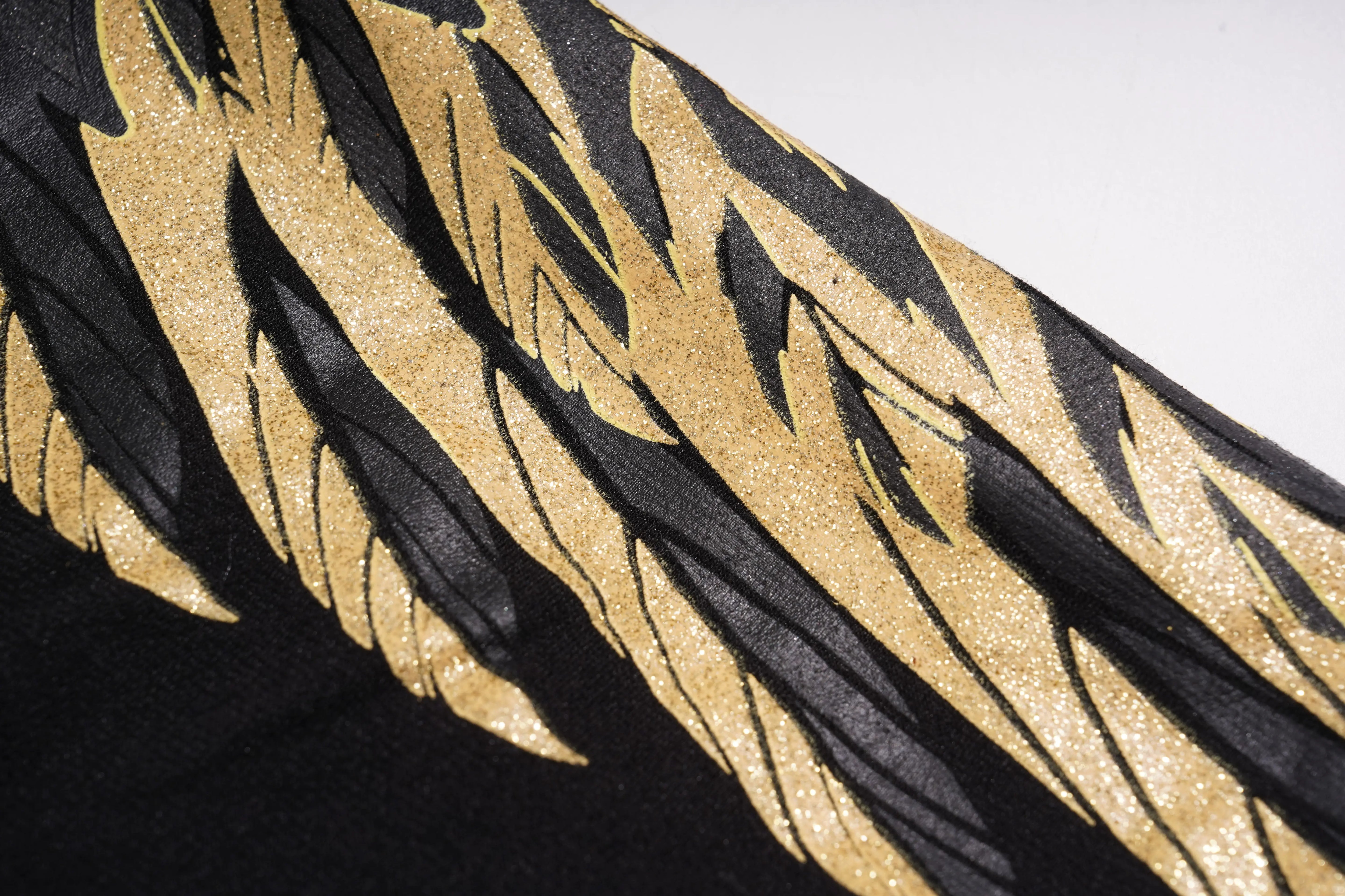 Close-up of black and gold patterned fabric, TCH Rhinestone Angel Wing Black Dress