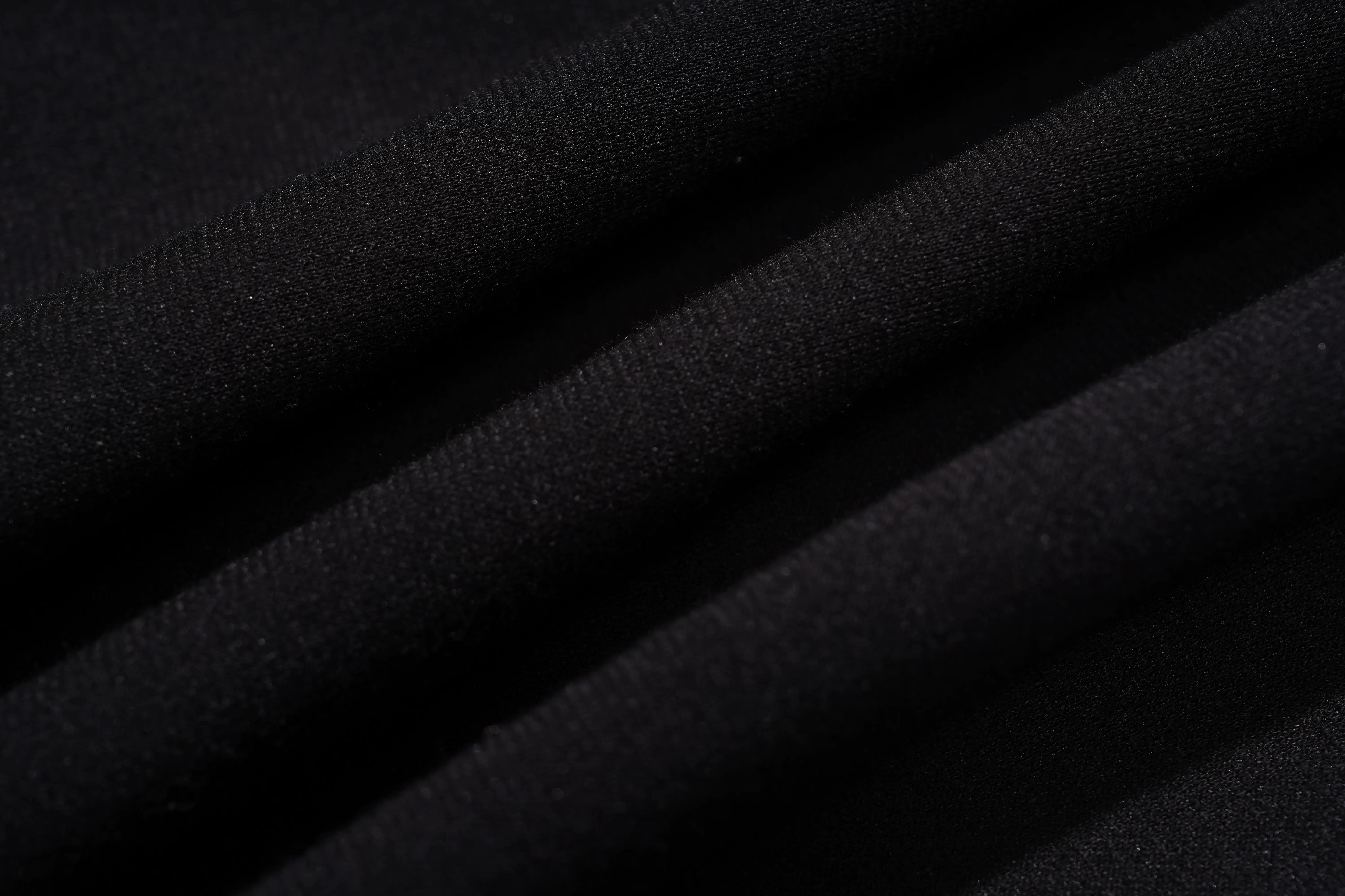 Close-up of black fabric with visible texture TCH Rhinestone Angel Wing Black Dress