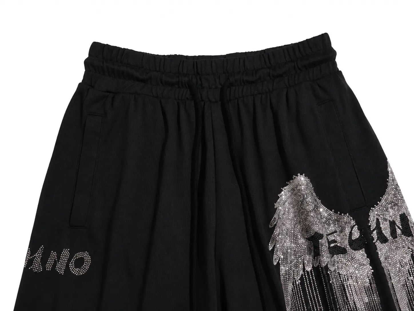 Black wide-leg pants featuring a silver rhinestone angel wing graphic on the right leg and a matching silver rhinestone logo on the left leg, shown against a plain white background. TCH Rhinestone Angel Wing Graphic Shorts