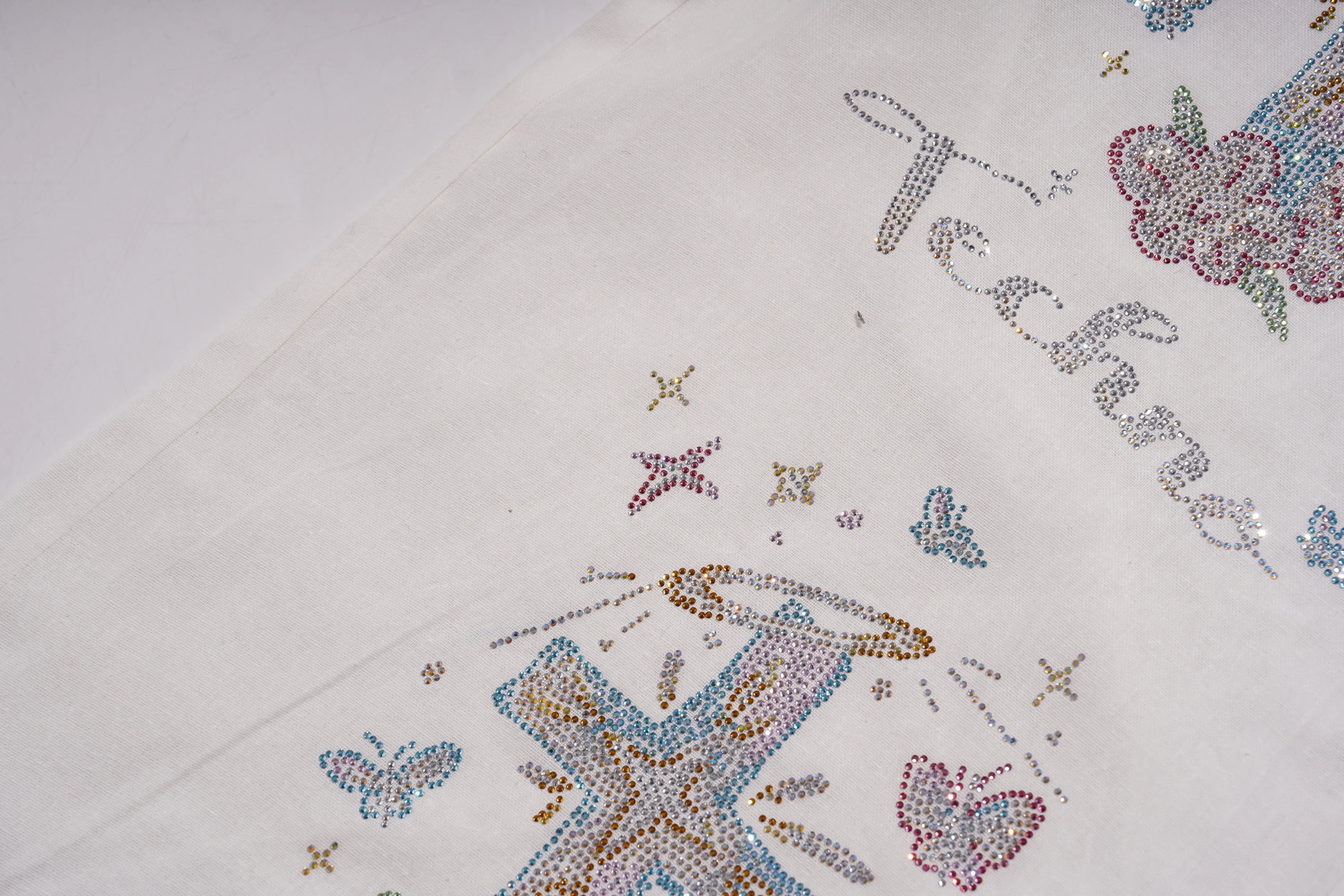 Decorative fabric with rhinestone patterns and text on a white background, TCH Rhinestone Angel Wings & Cross Set