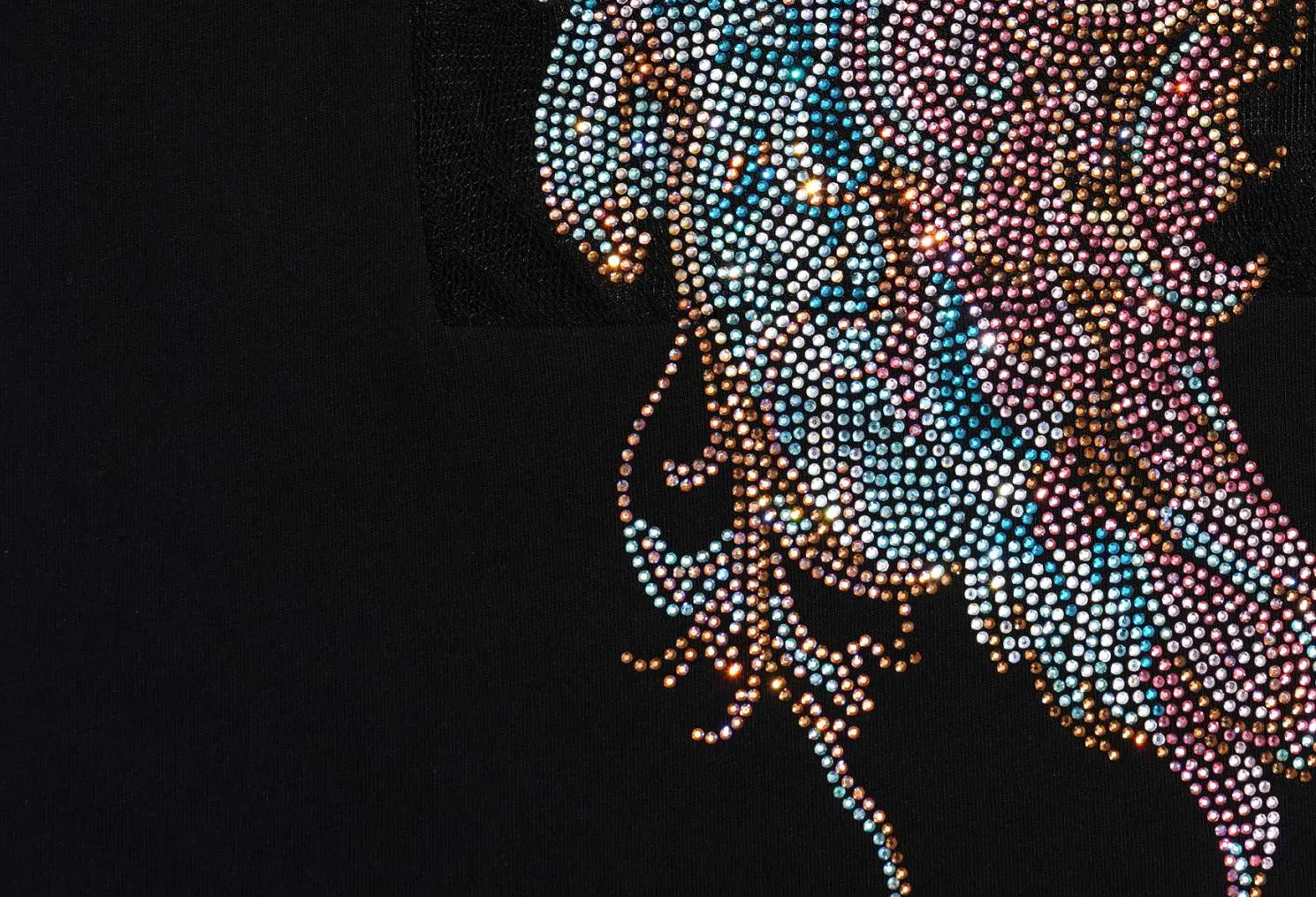 Close-up of a black garment featuring an intricate, multicolored rhinestone or bead applique design on the upper right side. TCH Rhinestone Angel Wings Graphic T-Shirt