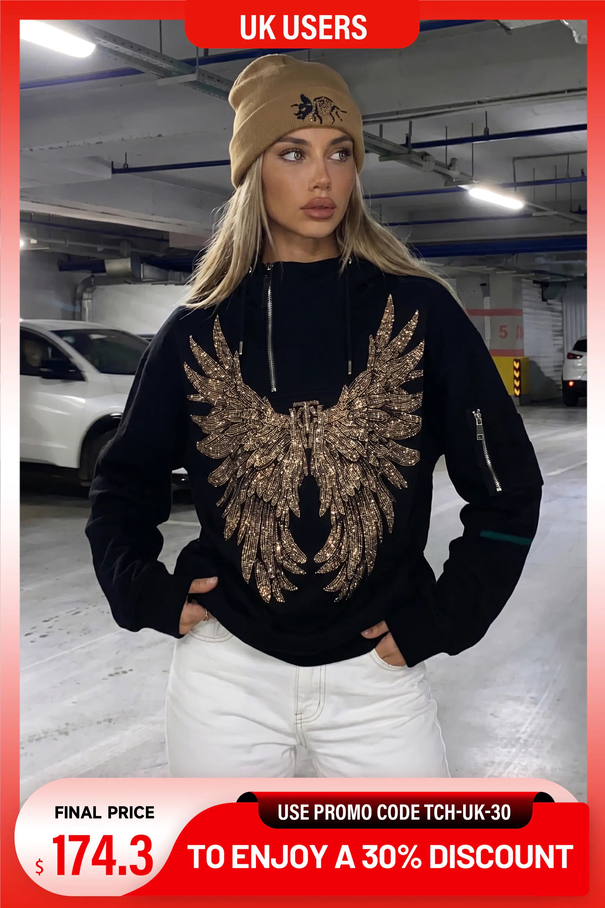 A woman wearing a black hoodie with a large gold sequined eagle design on the front, paired with white pants and a tan beanie, standing in a parking garage. The image has promotional overlays for a UK users discount. TCH Rhinestone Angel Wings Hoodie