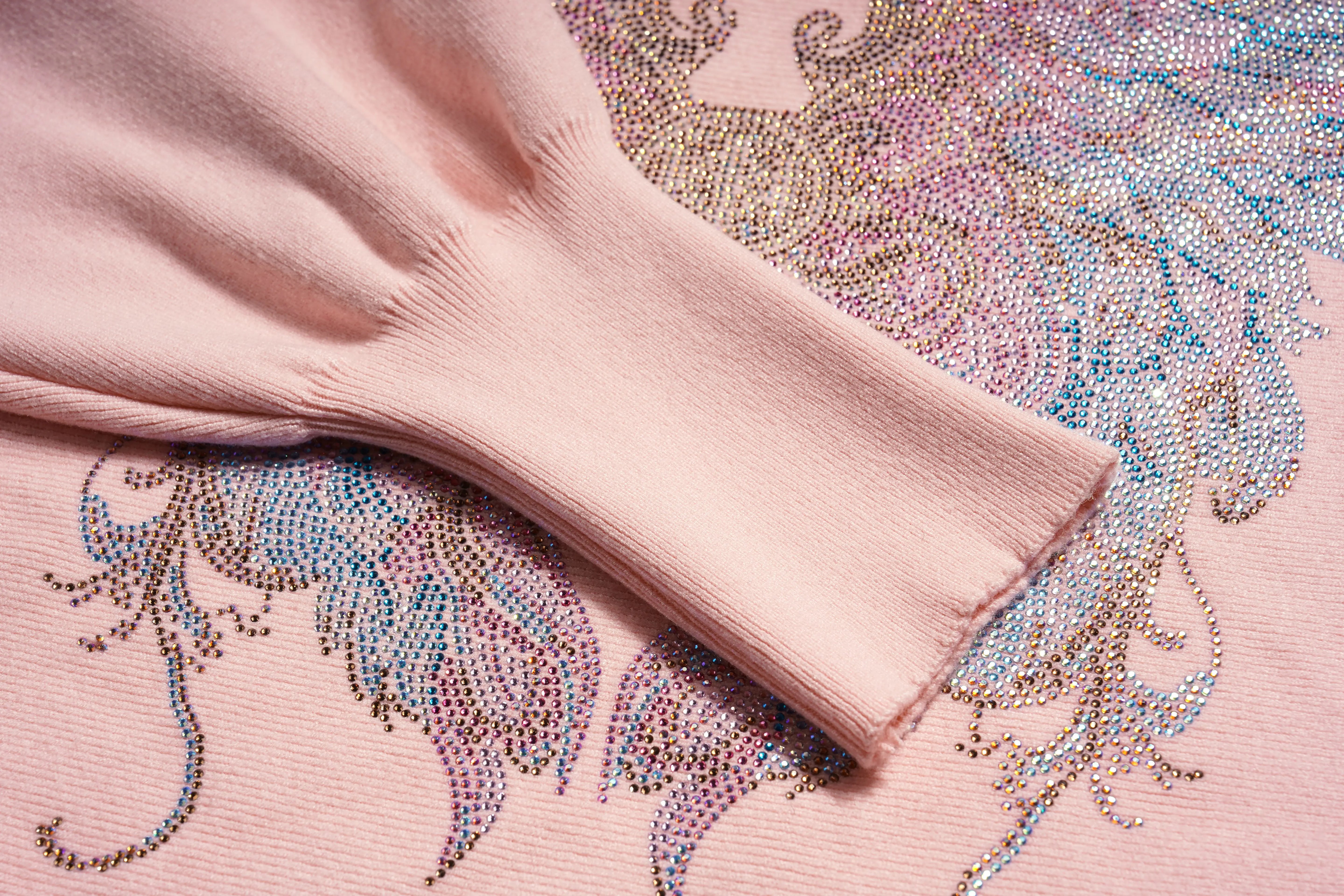 Pink sweater with decorative rhinestone patterns on a pink background, TCH Rhinestone Angel Wings Layered Knit Top & Wide-Leg Pants Set