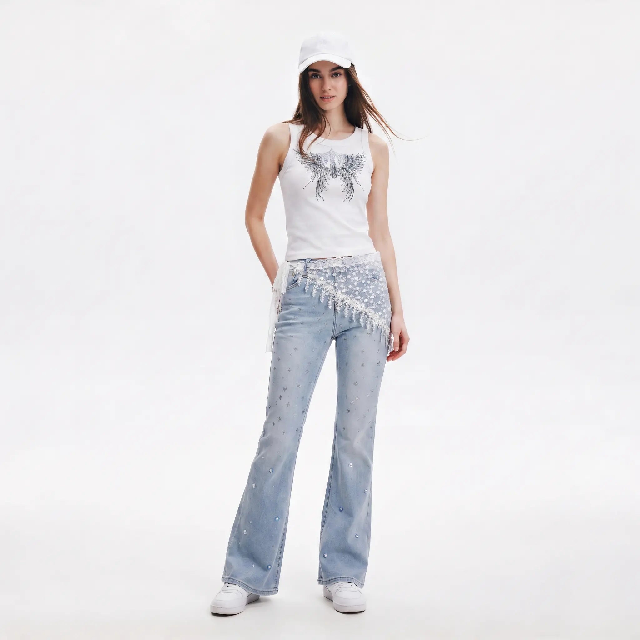 Woman wearing a white tank top, light blue jeans, and a white cap on a white background, TCH Rhinestone Angel Wings Ribbed Tank Top