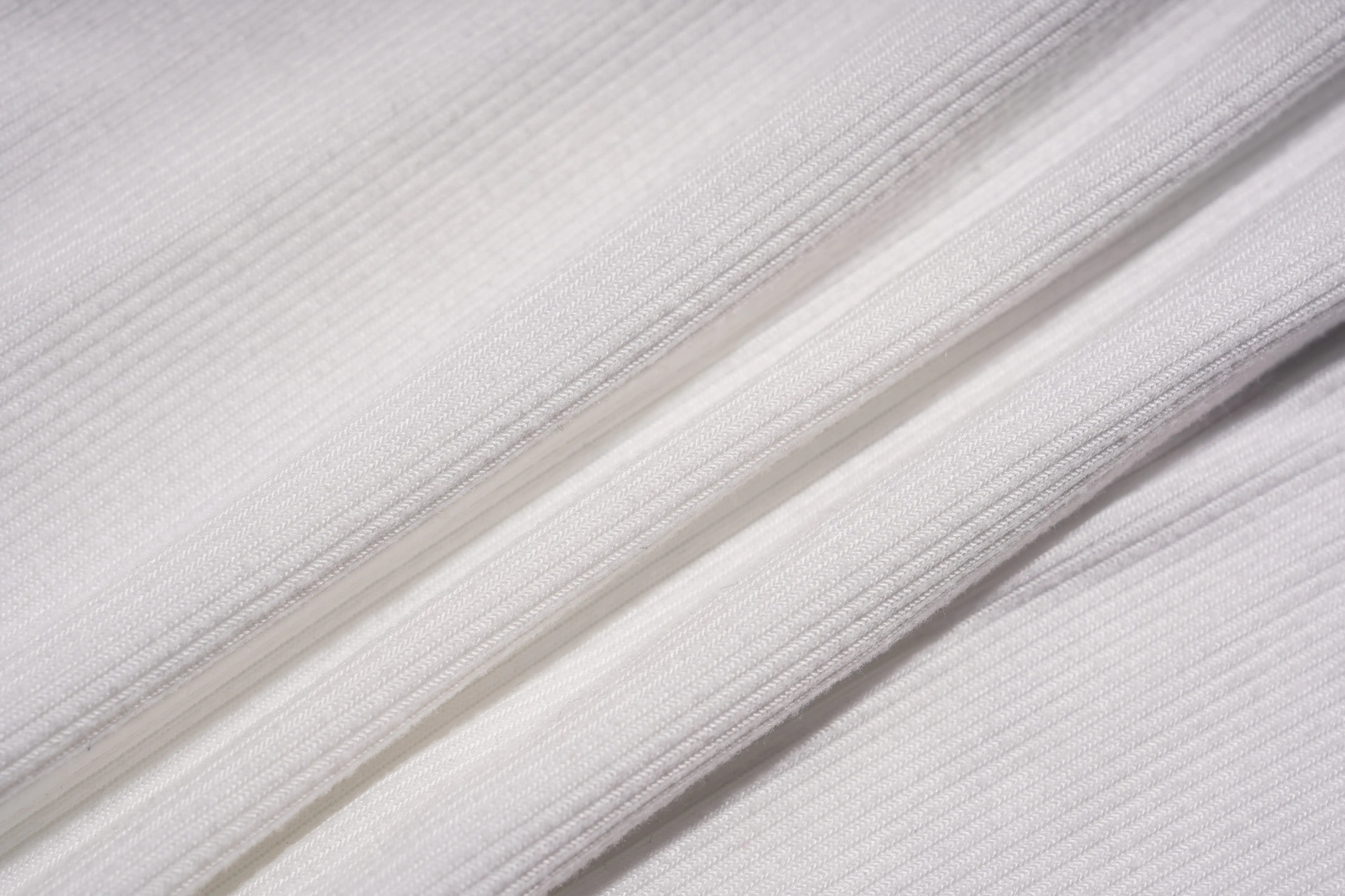 Close-up of white fabric with visible texture, TCH Rhinestone Angel Wings Ribbed Tank Top