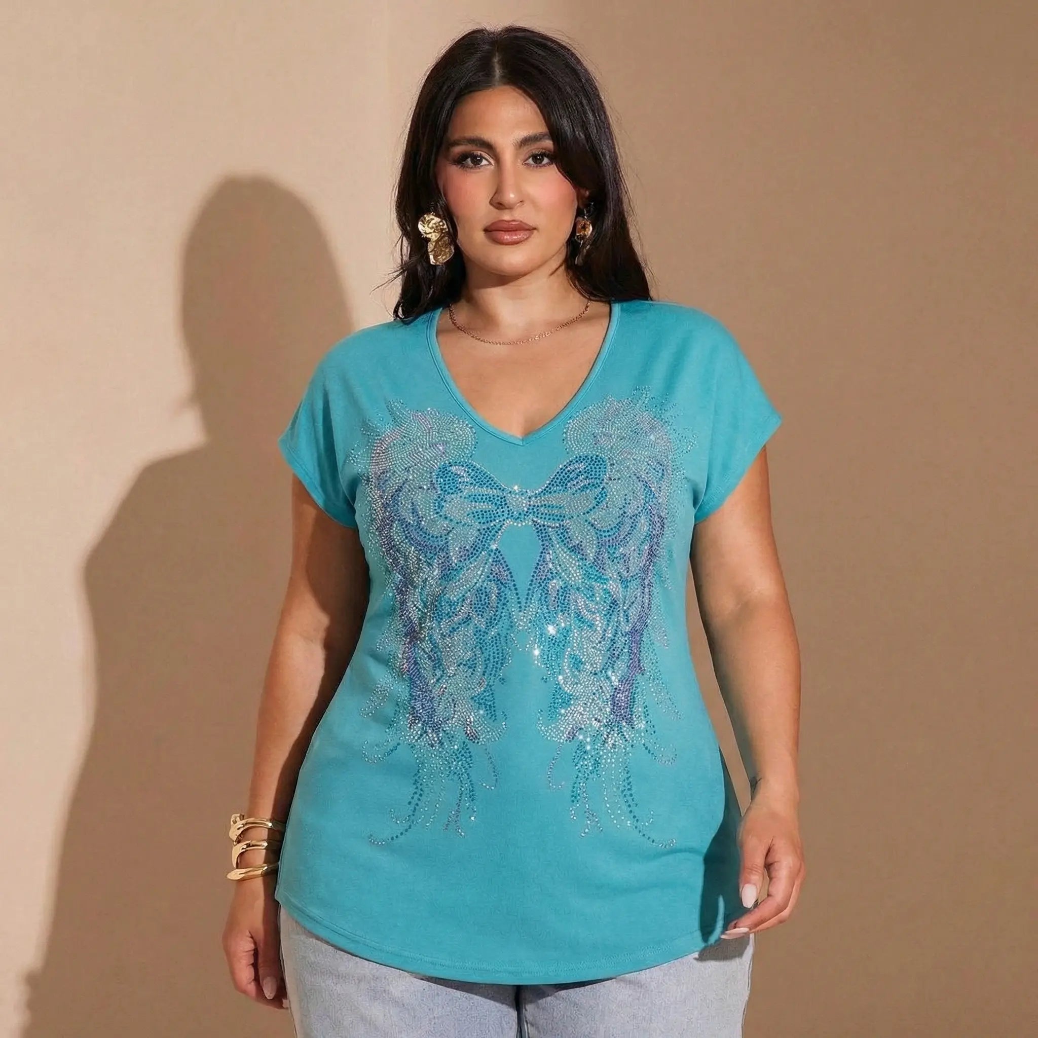Woman wearing a turquoise shirt with butterfly design against a beige background, TCH Rhinestone Angel Wings V-Neck T-Shirt