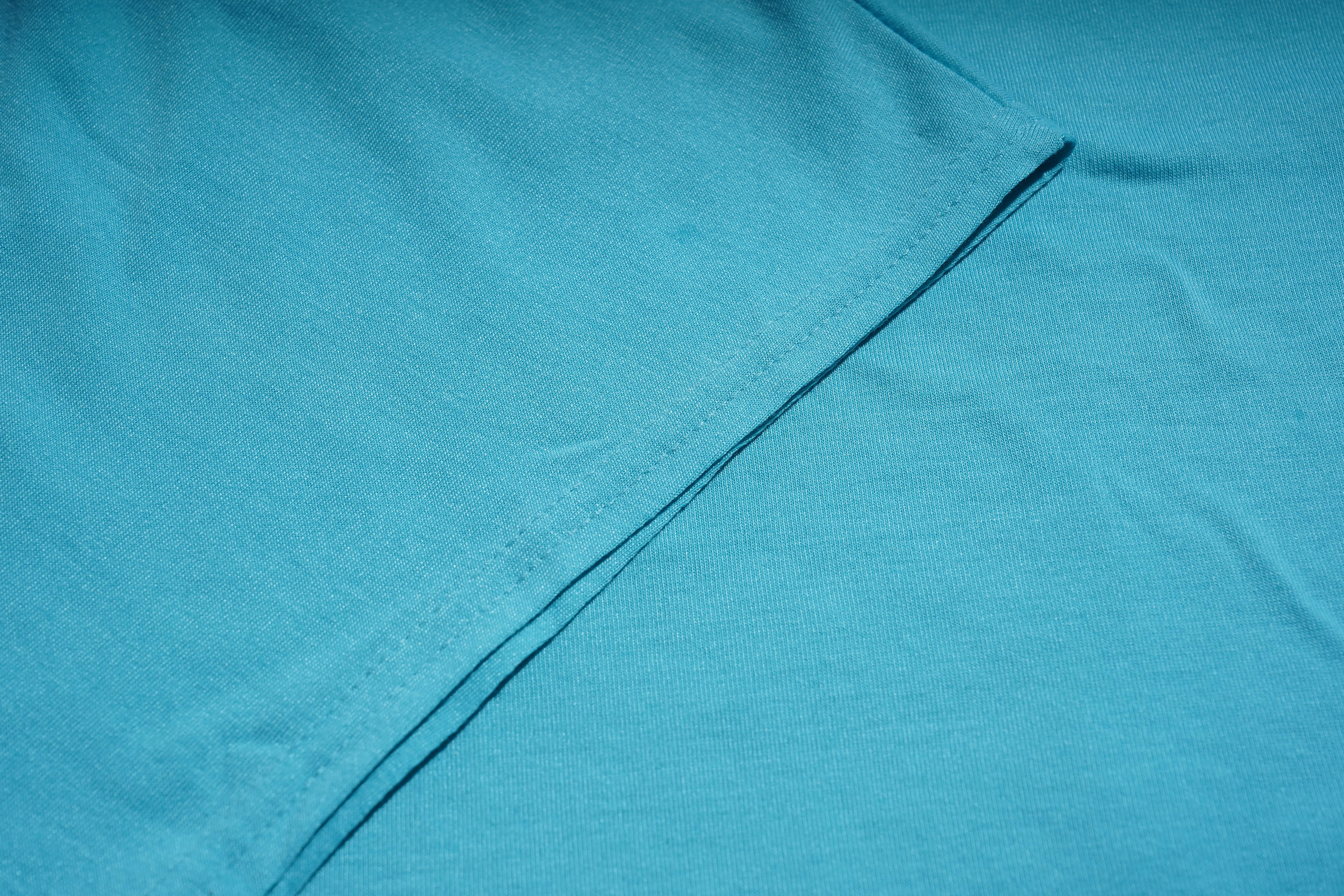 Close-up of blue fabric with a visible seam, TCH Rhinestone Angel Wings V-Neck T-Shirt