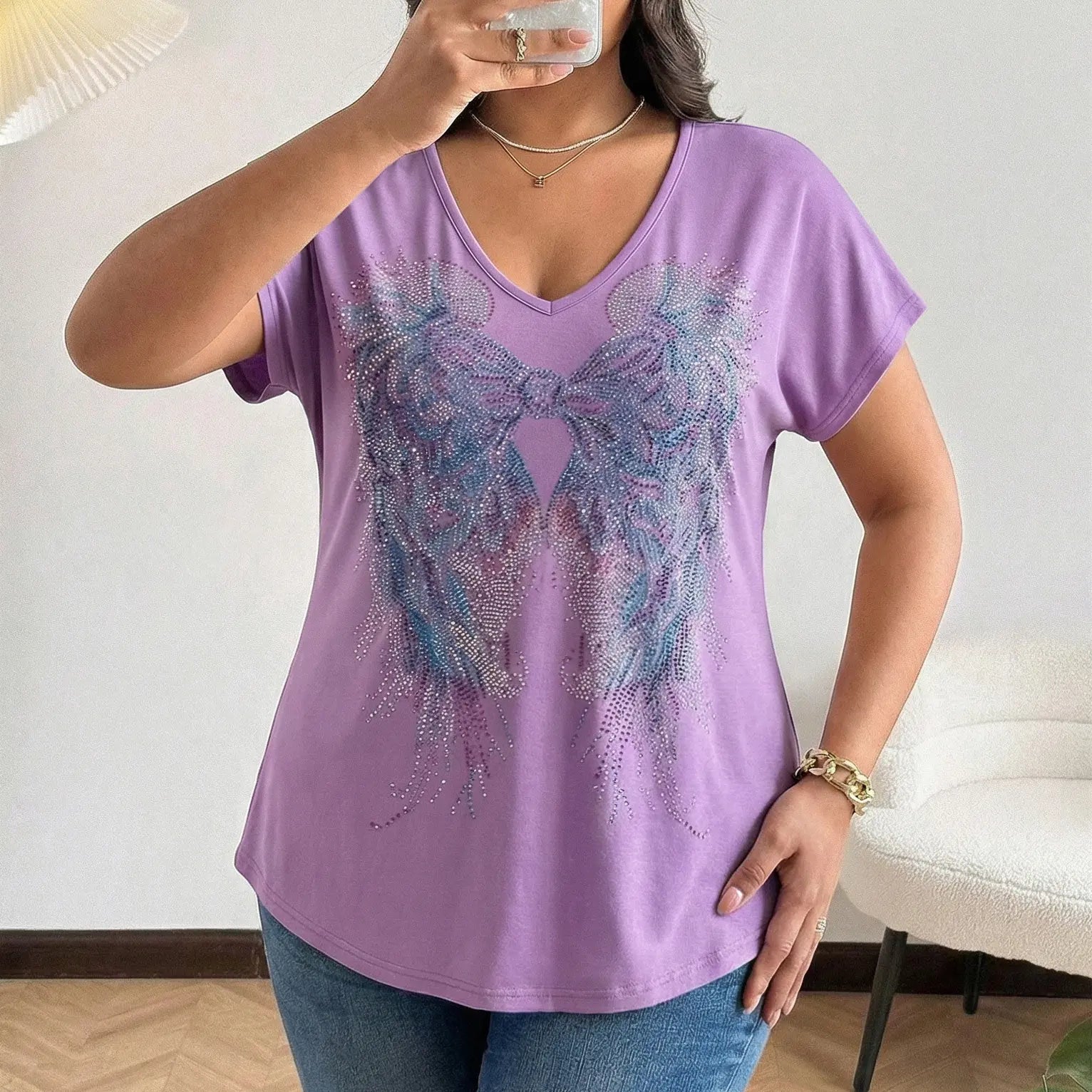 Person wearing a purple t-shirt with a decorative design, standing indoors. TCH Rhinestone Angel Wings V-Neck T-Shirt