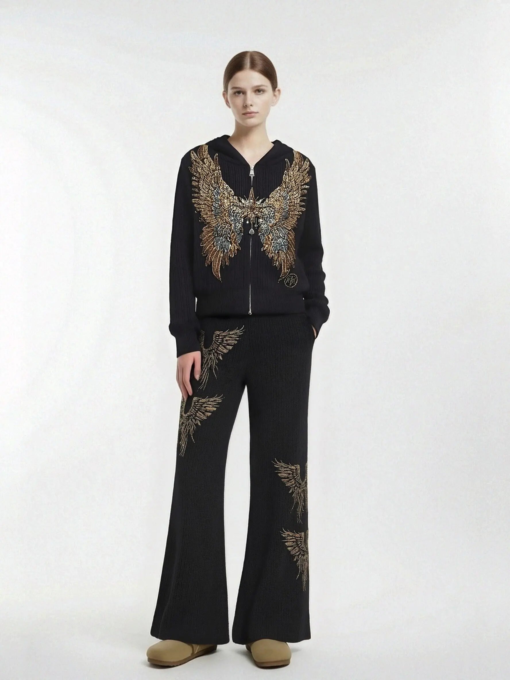Model wearing a black outfit with intricate gold embroidery on a white background, TCH Rhinestone Angel Wings Zip Hoodie & Flare Pants Set
