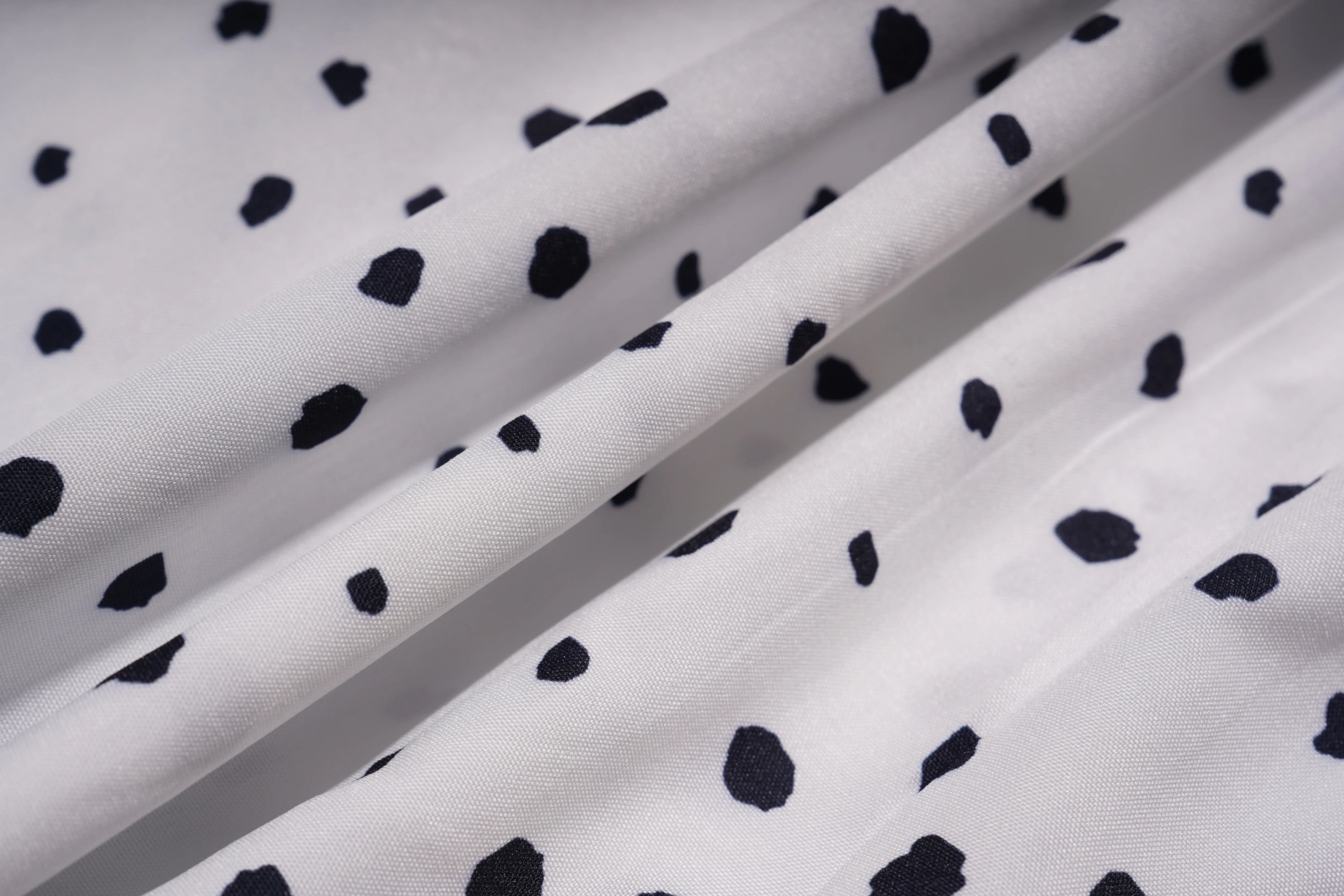 White fabric with black polka dot pattern, TCH Rhinestone Animal Polka Dot Shirt