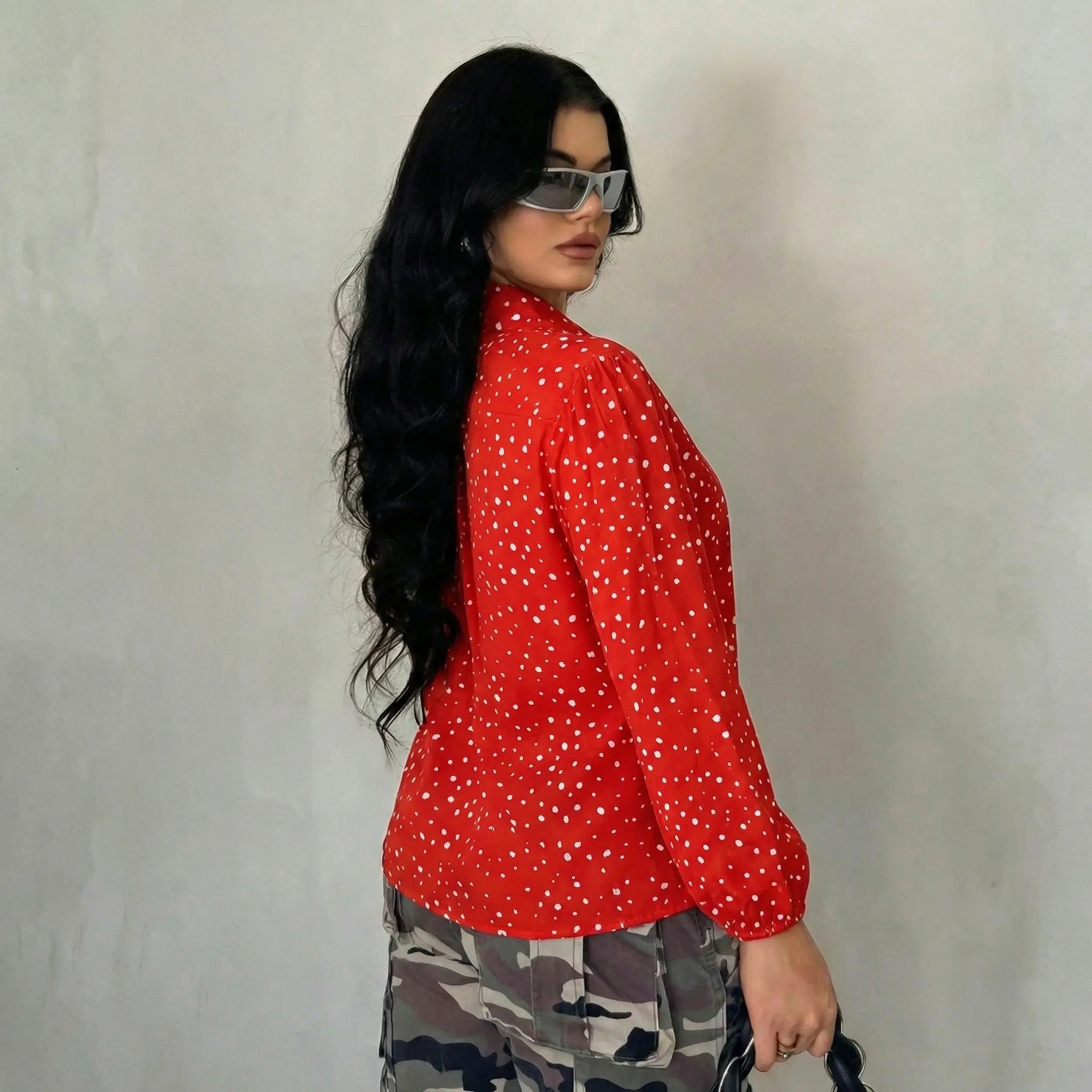 Woman wearing a red polka dot shirt and camouflage pants against a plain background, TCH Rhinestone Animal Polka Dot Shirt