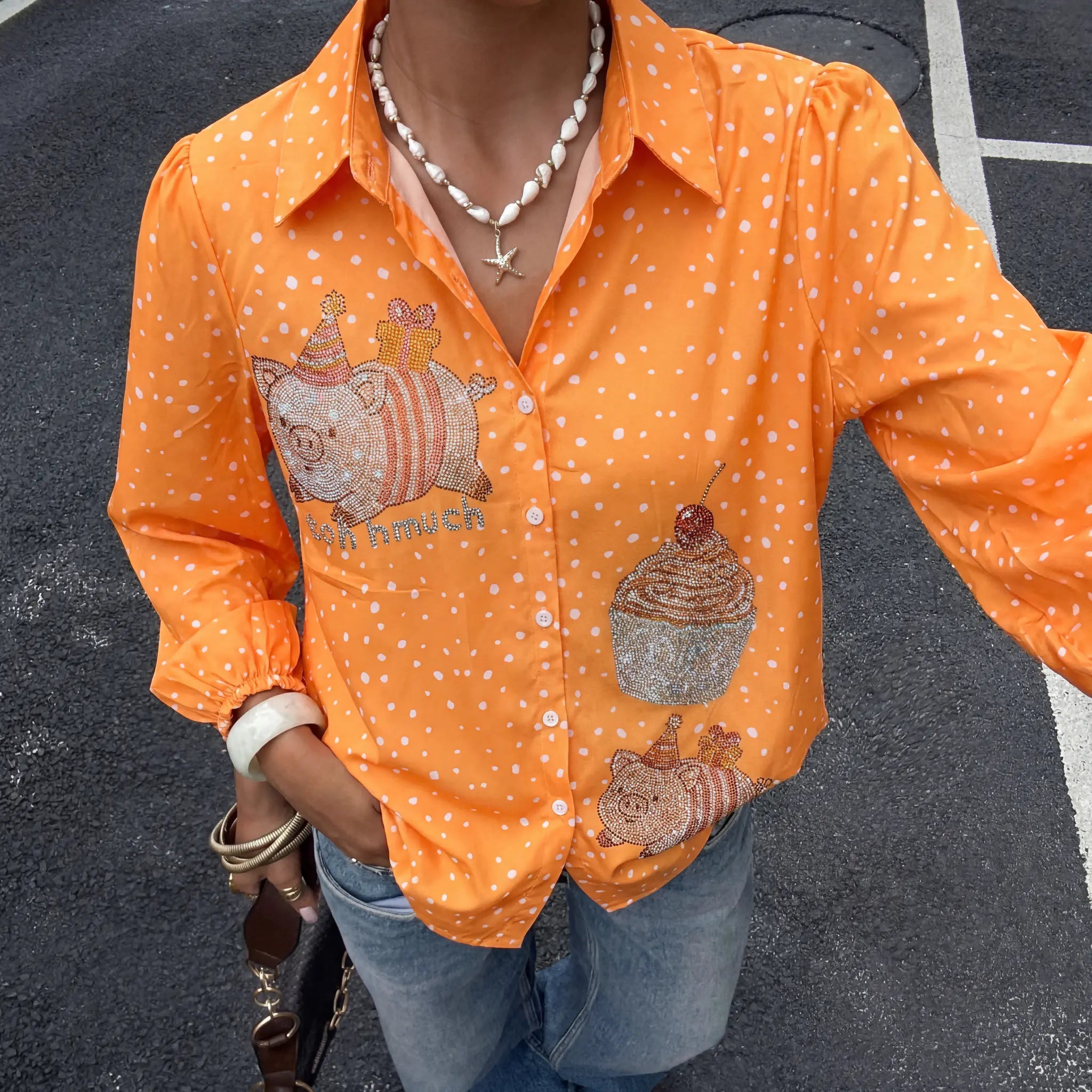 Person wearing an orange shirt with cartoon designs on a dark background, TCH Rhinestone Animal Polka Dot Shirt