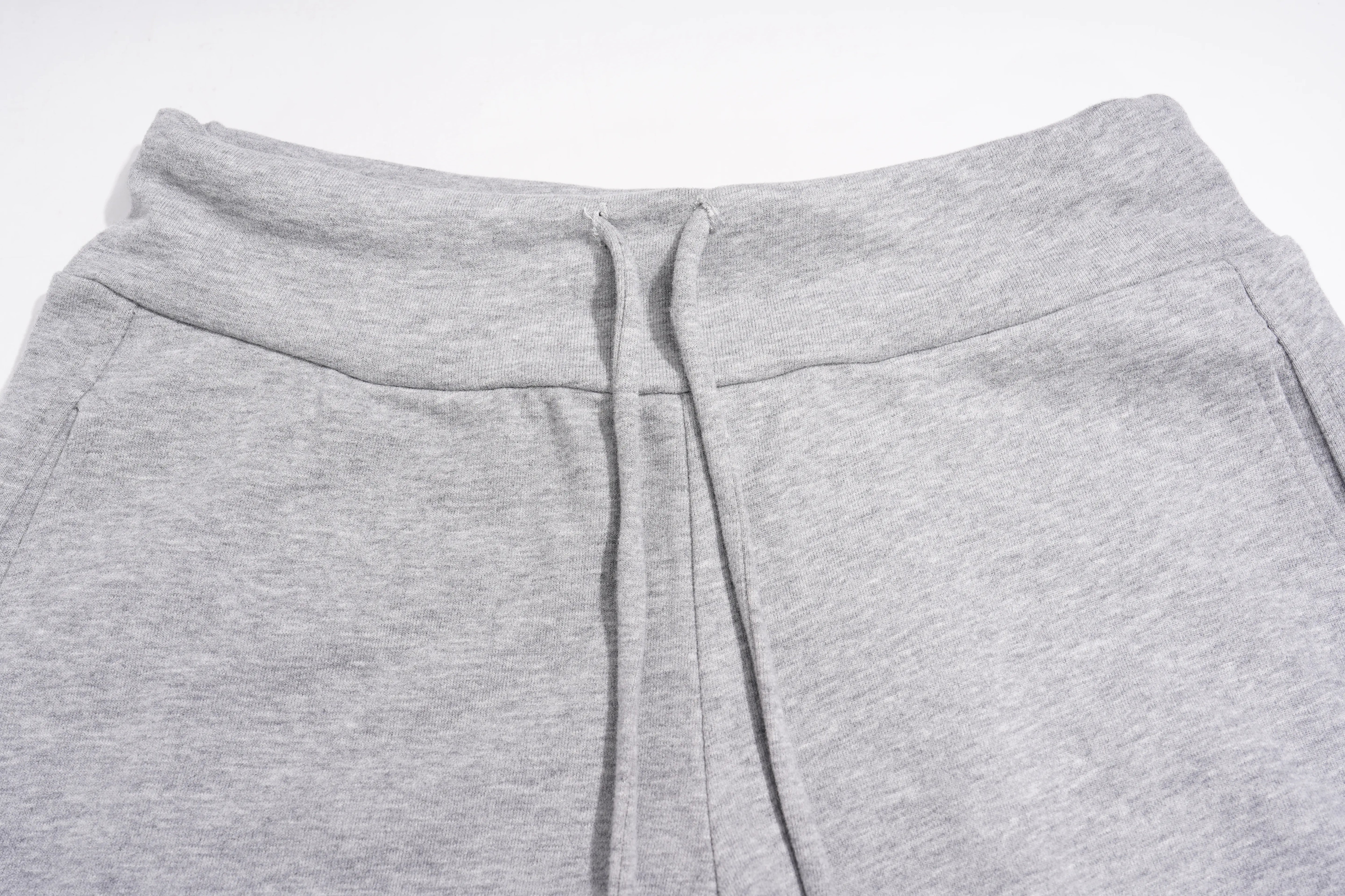 Close-up of the waistband of light gray heather sweatpants, showing the drawstring hanging down against a plain white background. TCH Rhinestone Bow 3-Piece Lounge Set
