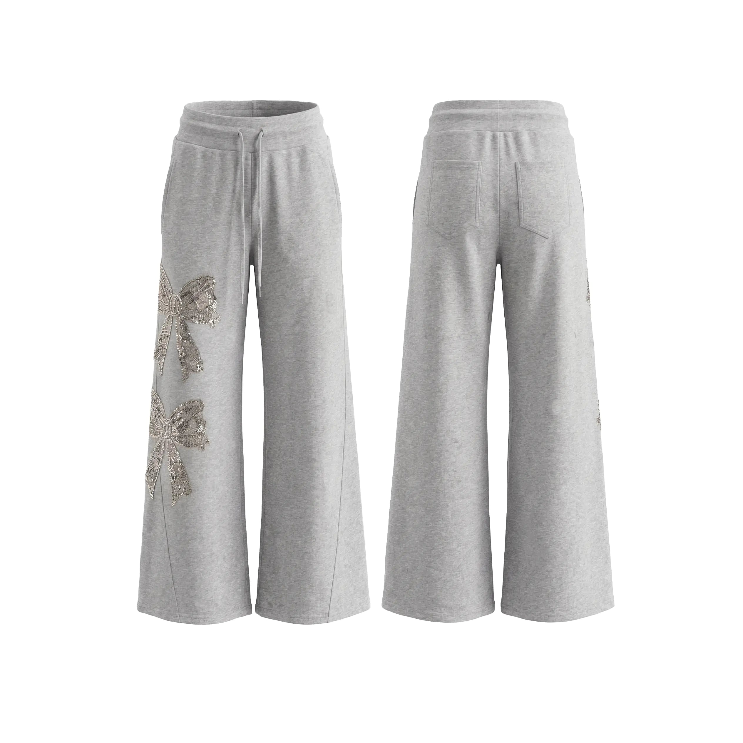A pair of light gray wide-leg sweatpants shown from both the front and back views. The front view features a drawstring waist and a large, textured metallic silver bow embellishment on the left leg. TCH Rhinestone Bow 3-Piece Lounge Set