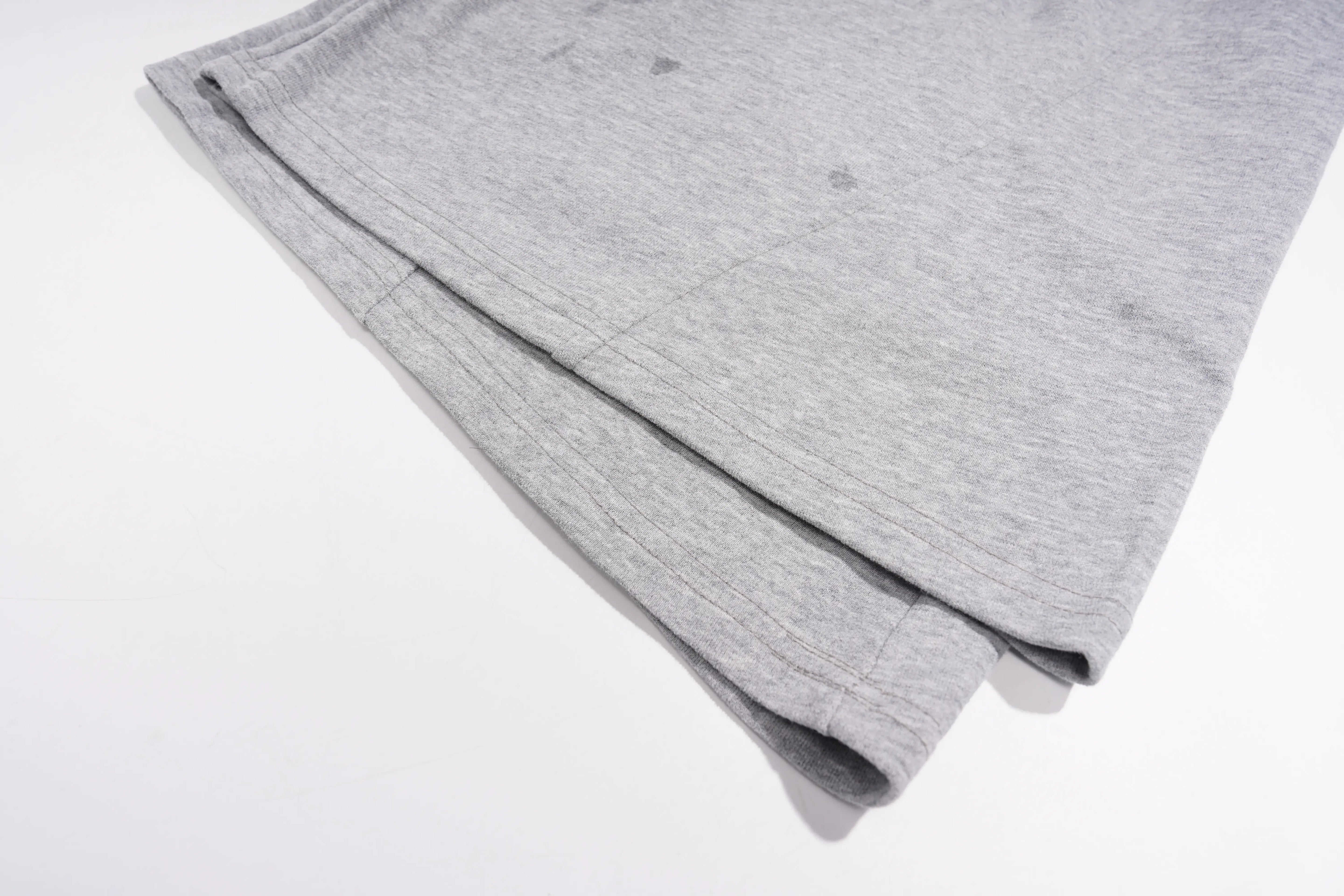 A close-up of a folded light gray heather fabric garment, showing the soft texture and ribbed edge, on a plain white background. TCH Rhinestone Bow 3-Piece Lounge Set