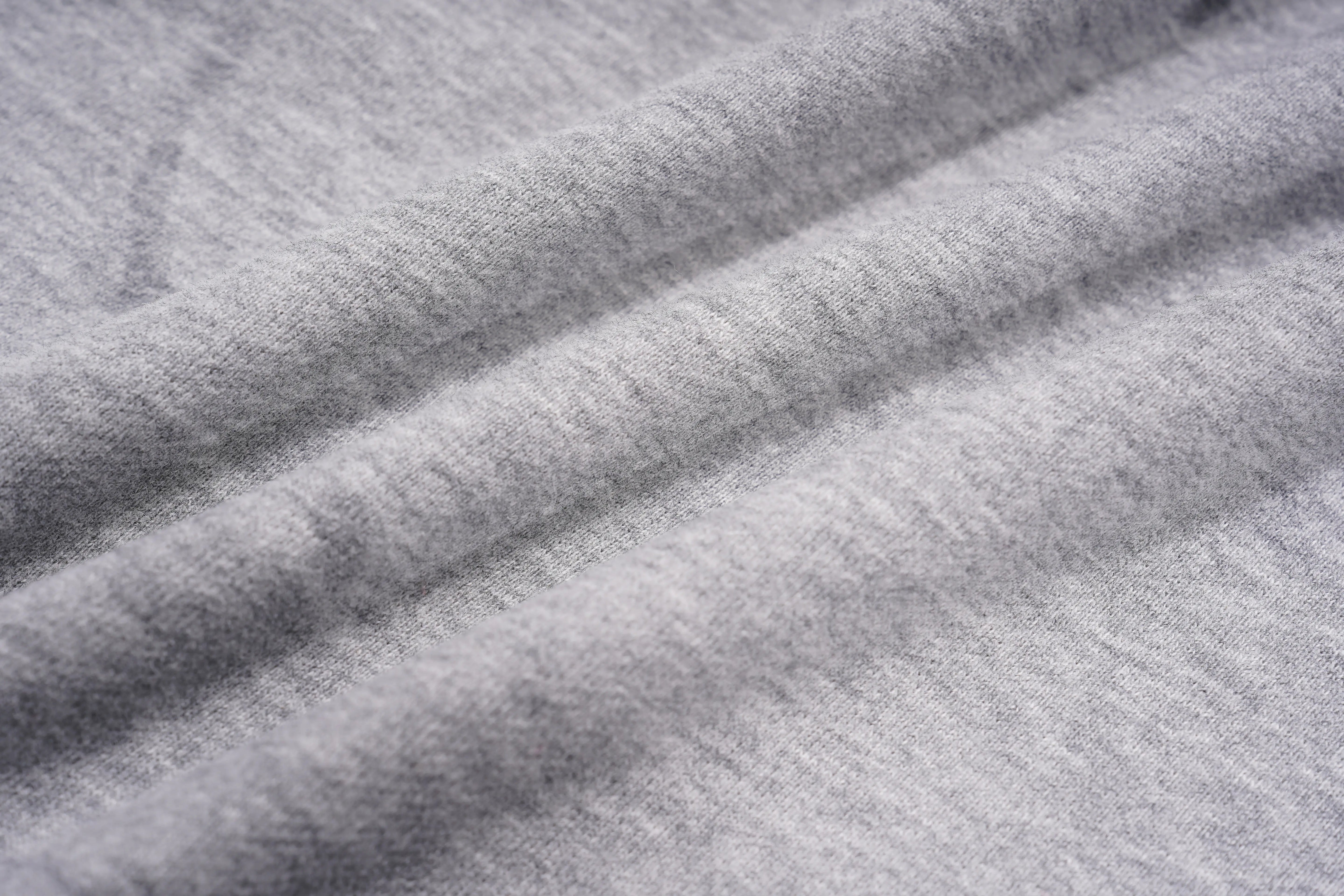 A close-up of light gray heathered fabric with soft folds and a smooth, slightly textured surface. TCH Rhinestone Bow 3-Piece Lounge Set