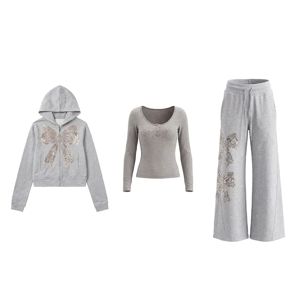 A three-piece women's loungewear set in heather gray, featuring a zip-up hoodie with a large sequined butterfly on the front, a scoop-neck long-sleeve top with a subtle sequin pattern on the chest, and matching wide-leg sweatpants with a large butterfly design on one leg. TCH Rhinestone Bow 3-Piece Lounge Set