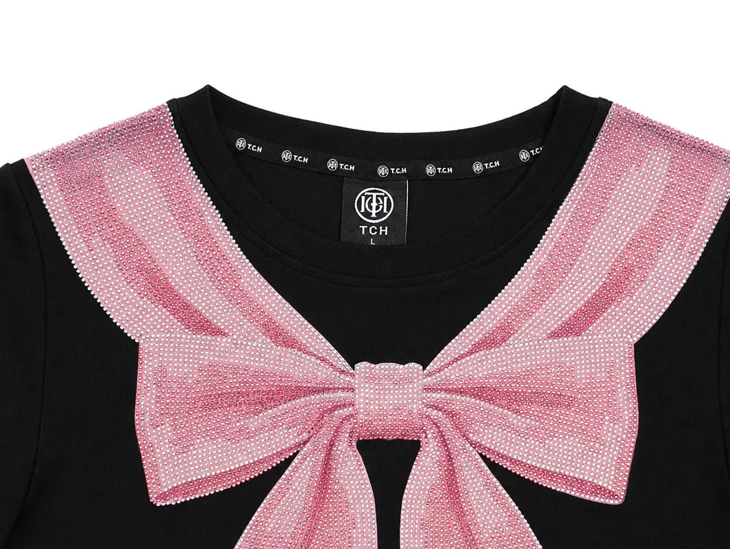 Close-up of a black top with a large pink sequined bow and matching pink sequined collar trim, shown against a white background. TCH Rhinestone Bow Collar Black Mini Dress