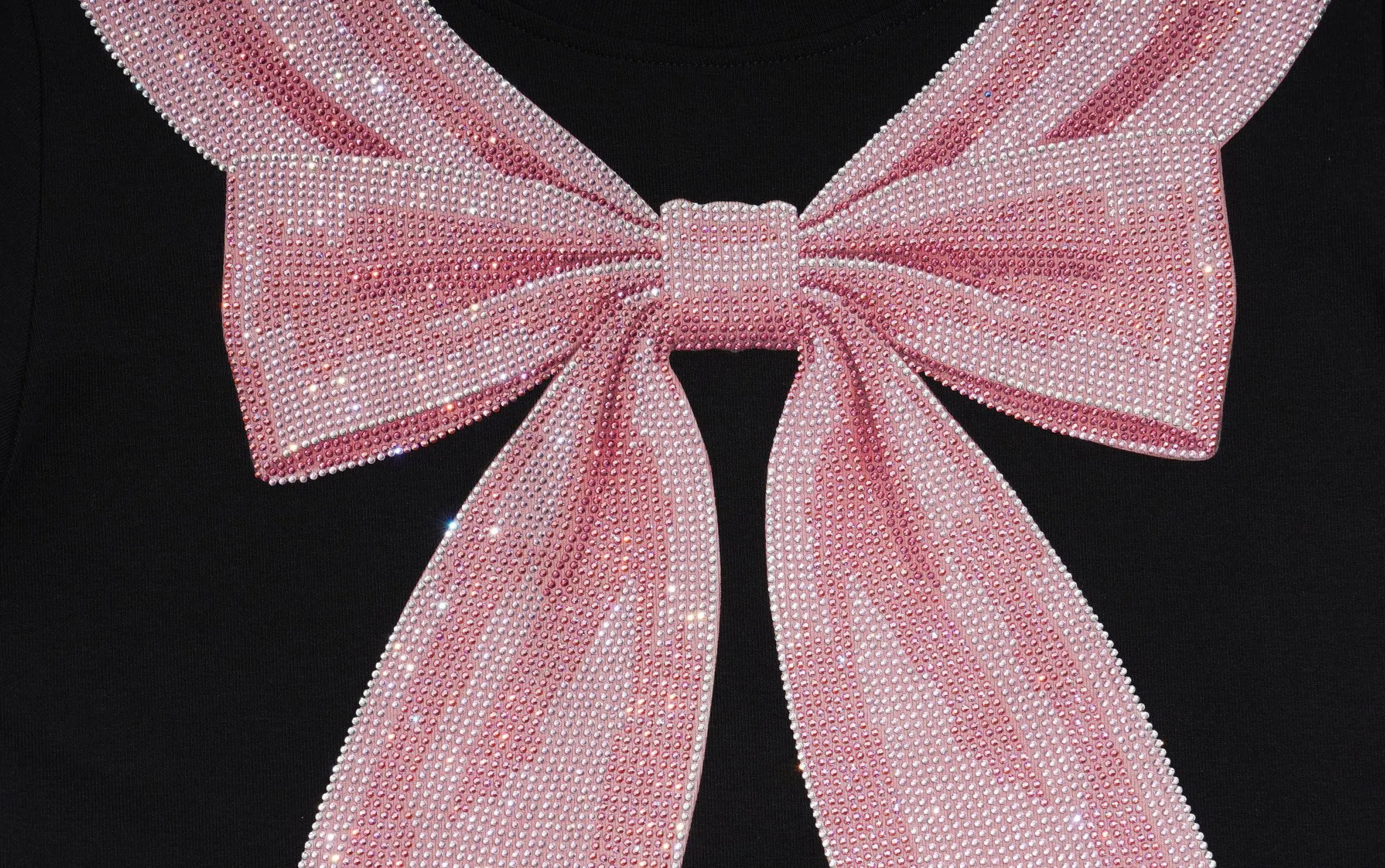 A close-up of a large pink sequined bow detail on a black garment, showing the texture and sparkle of the rhinestones. TCH Rhinestone Bow Collar Black Mini Dress