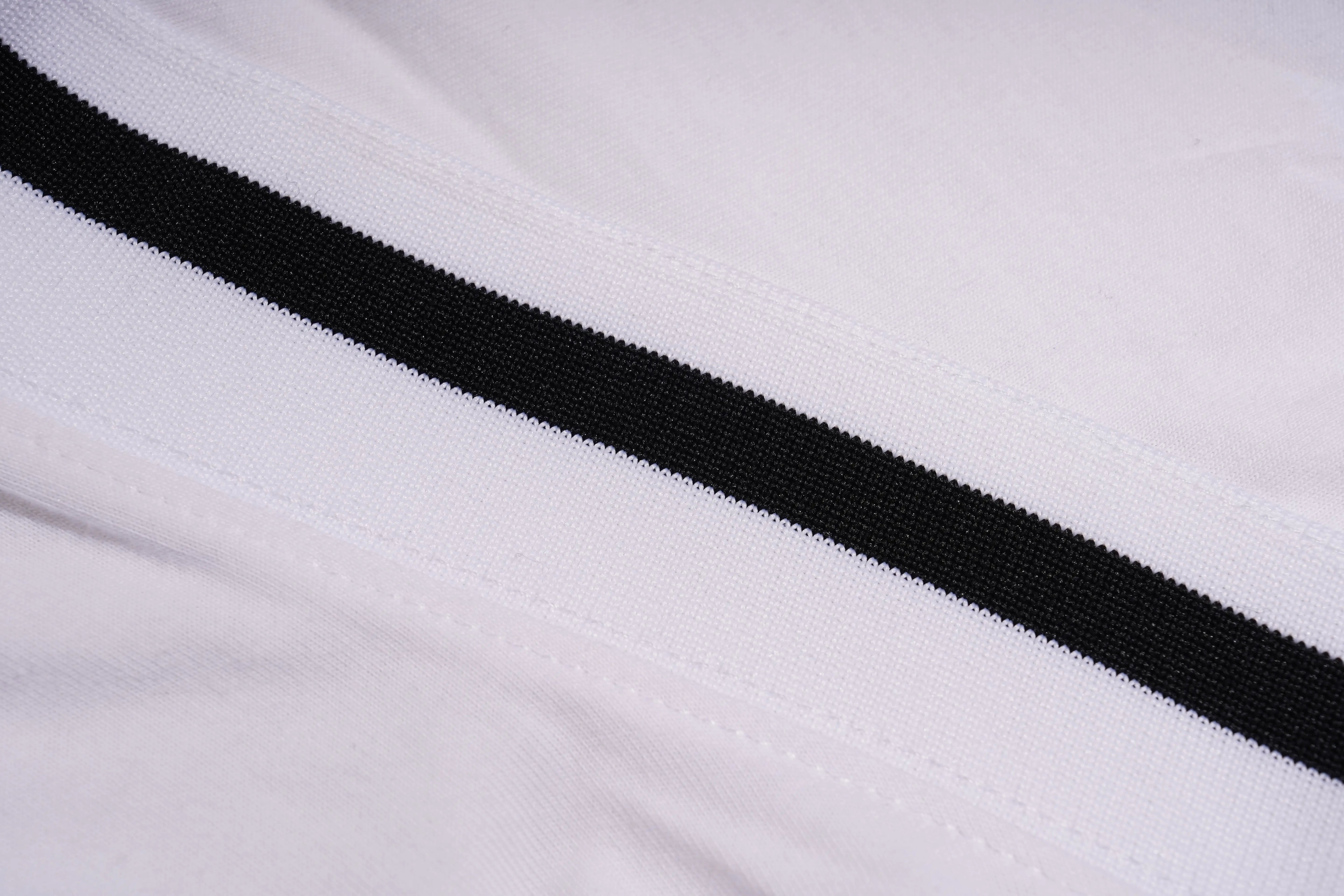 Close-up of a white fabric with a black stripe, TCH Rhinestone Bow White T-Shirt