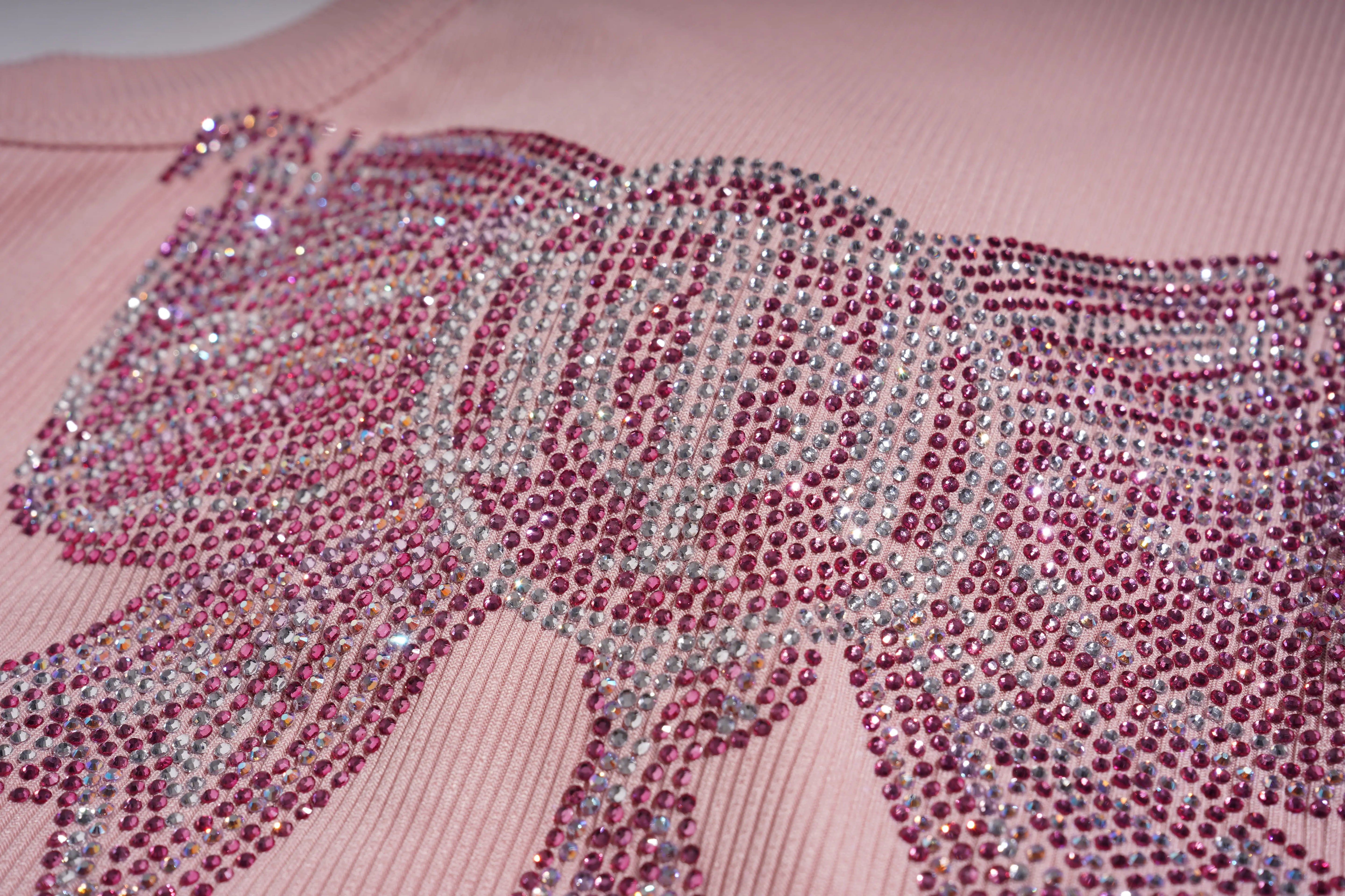 Pink garment with a horse design made of red and silver rhinestones. TCH Rhinestone Butterfly Bow Tank Top