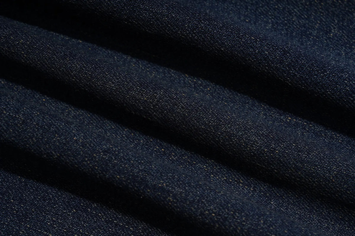 A close-up of dark navy blue denim fabric with a visible twill texture and soft diagonal folds. TCH Rhinestone Butterfly Charm Wide-Leg Denim Jeans