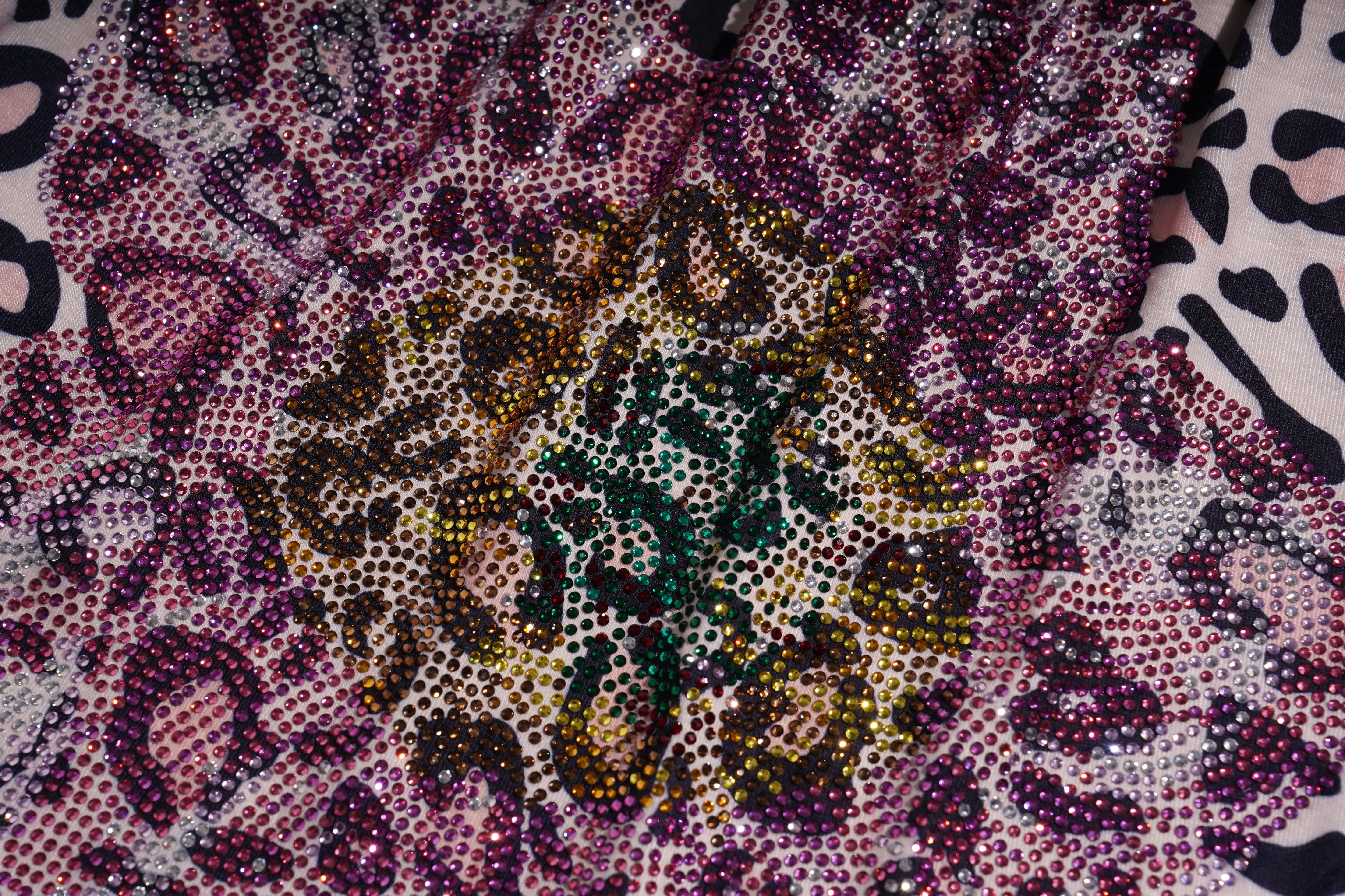 Close-up of a patterned fabric with a central design, TCH Rhinestone Butterfly & Floral Leopard Tube Top