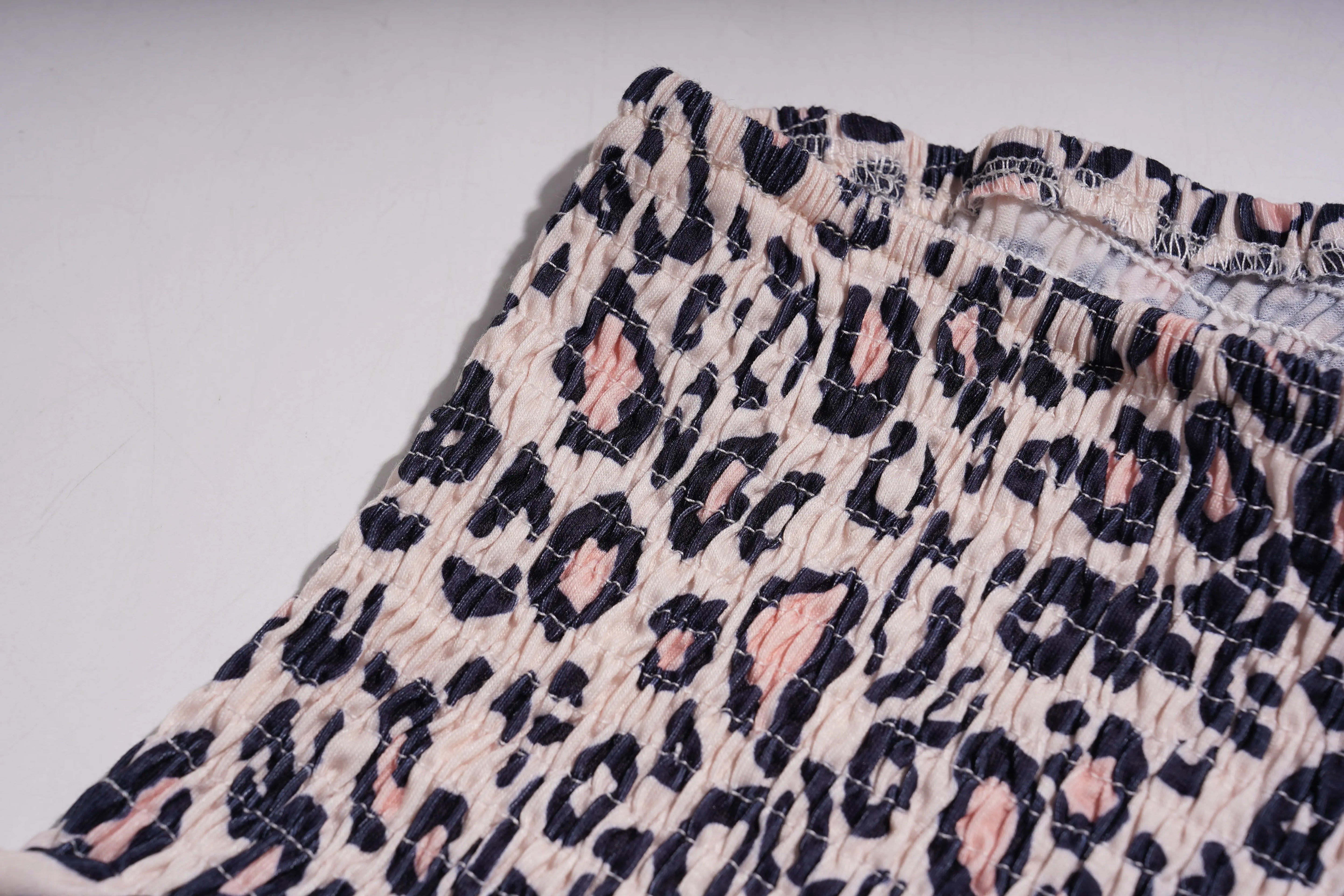 Close-up of leopard print fabric on a plain background, TCH Rhinestone Butterfly & Floral Leopard Tube Top