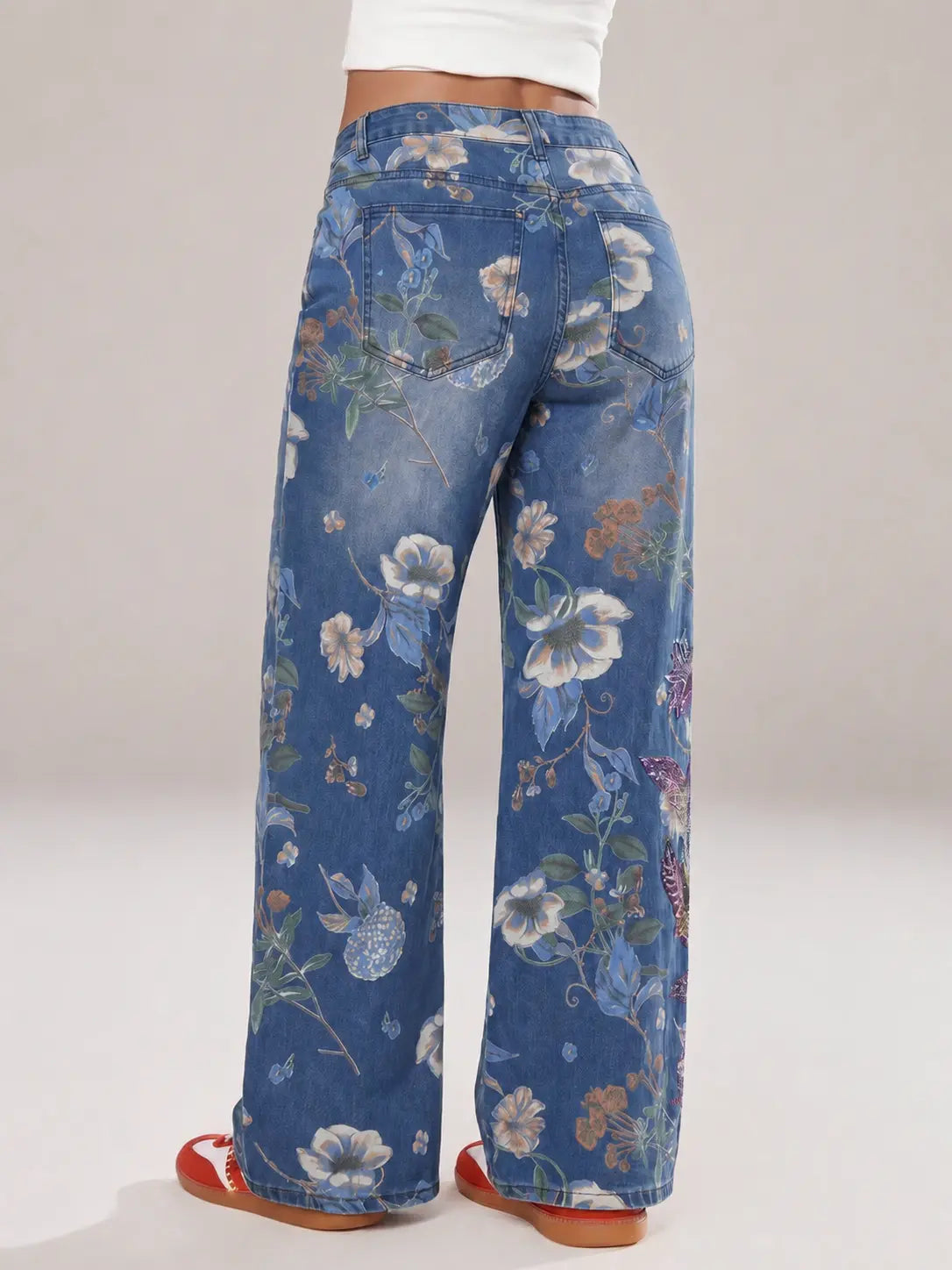 Blue floral-patterned jeans on a plain background, TCH Rhinestone Butterfly Floral Print Denim Jeans