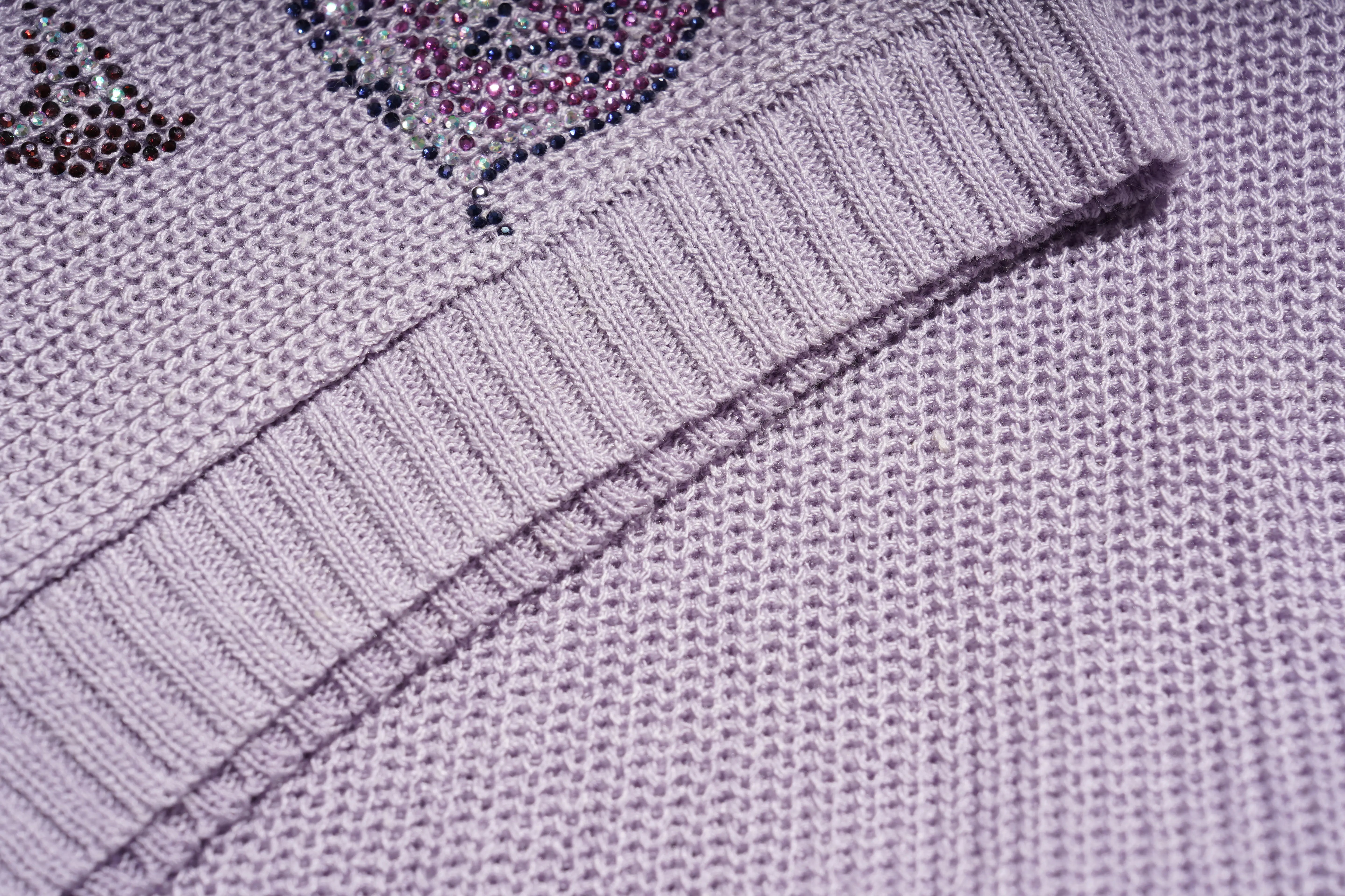 Close-up of a light lavender knit sweater showing the ribbed collar and textured knit fabric. TCH Rhinestone Butterfly Knit Twist Top