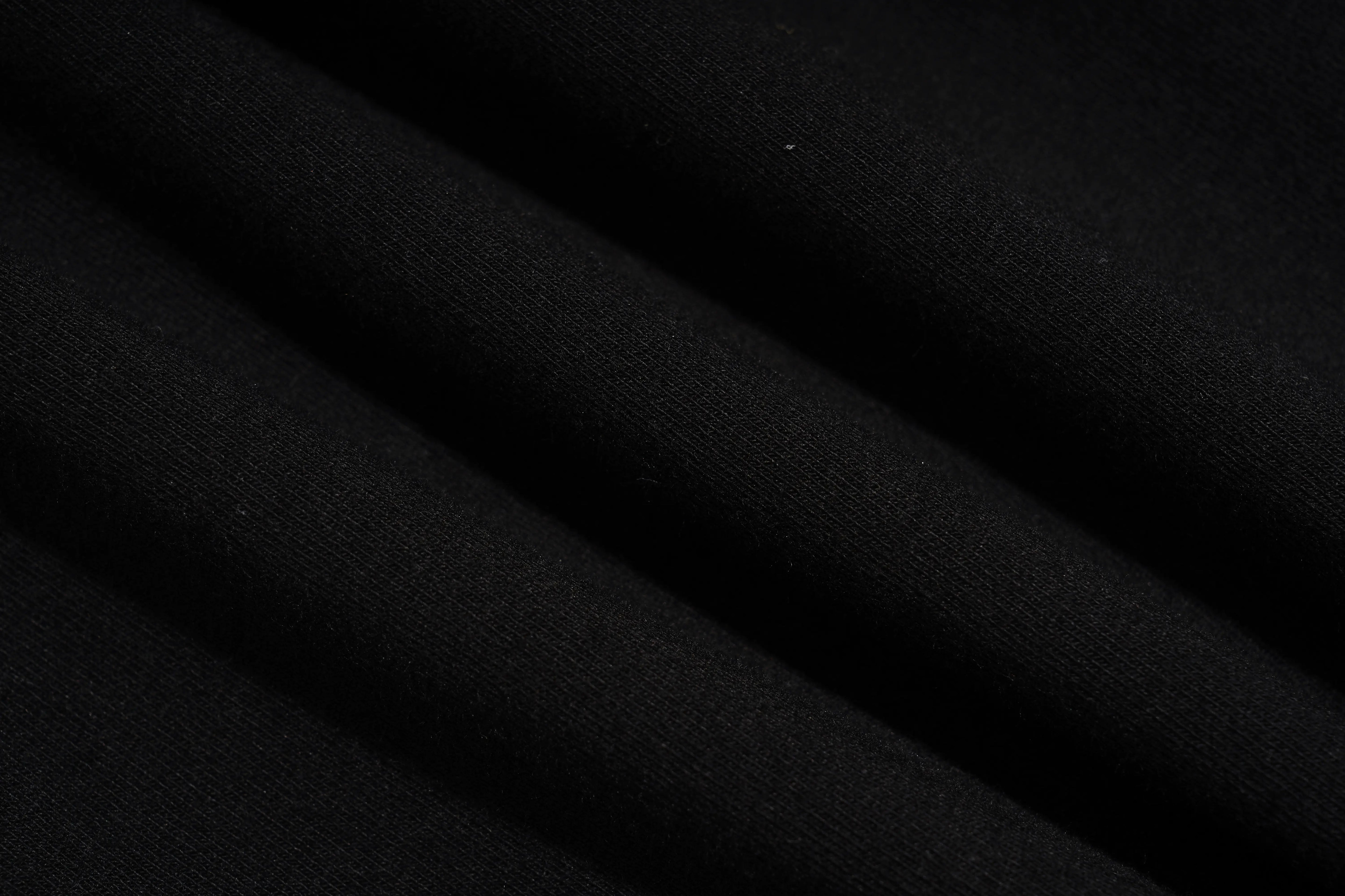 A close-up of draped black fabric with soft folds showing a fine knit texture. TCH Rhinestone Butterfly V-Neck Oversized Baseball T-Shirt