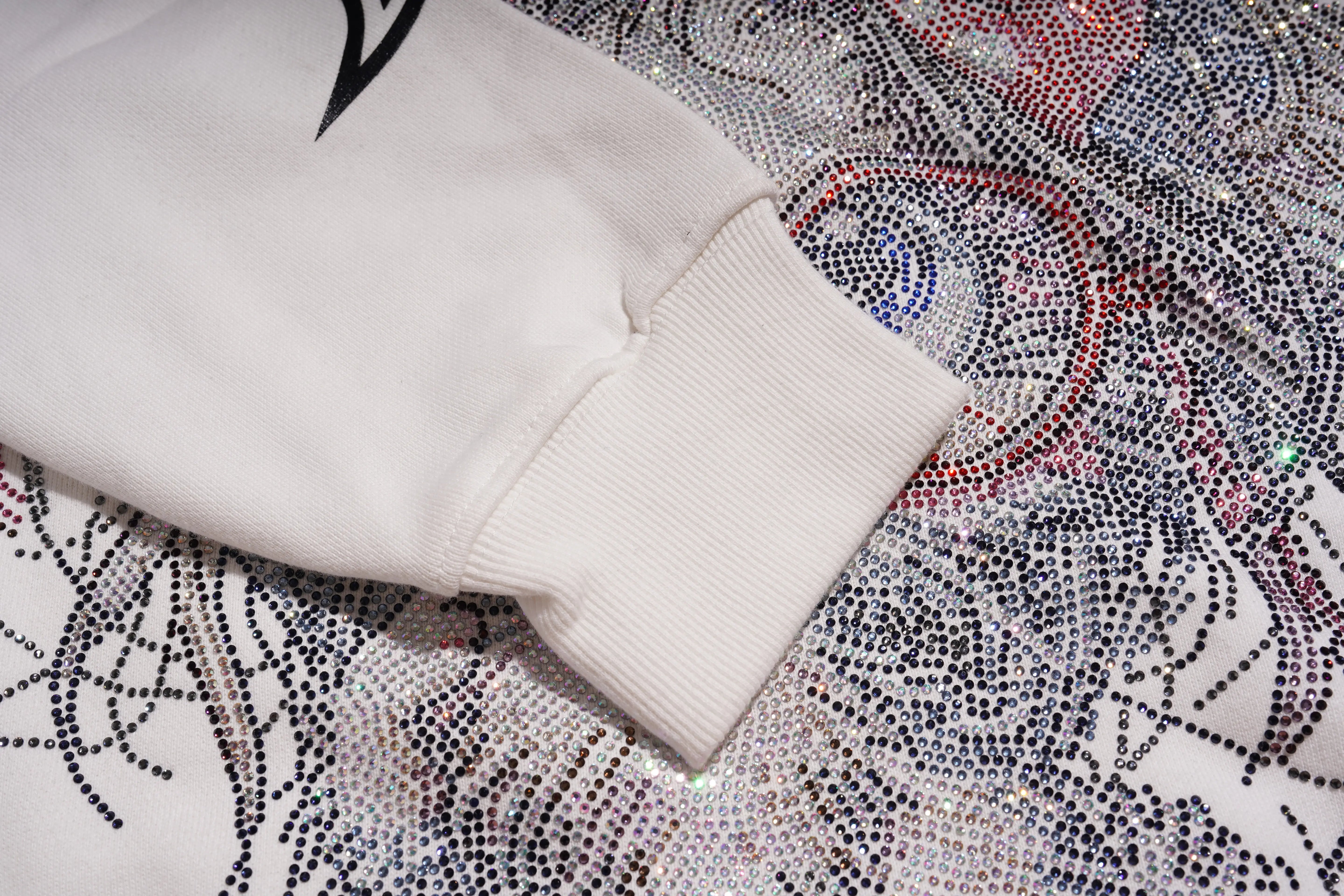 White sweatshirt sleeve on a patterned fabric background