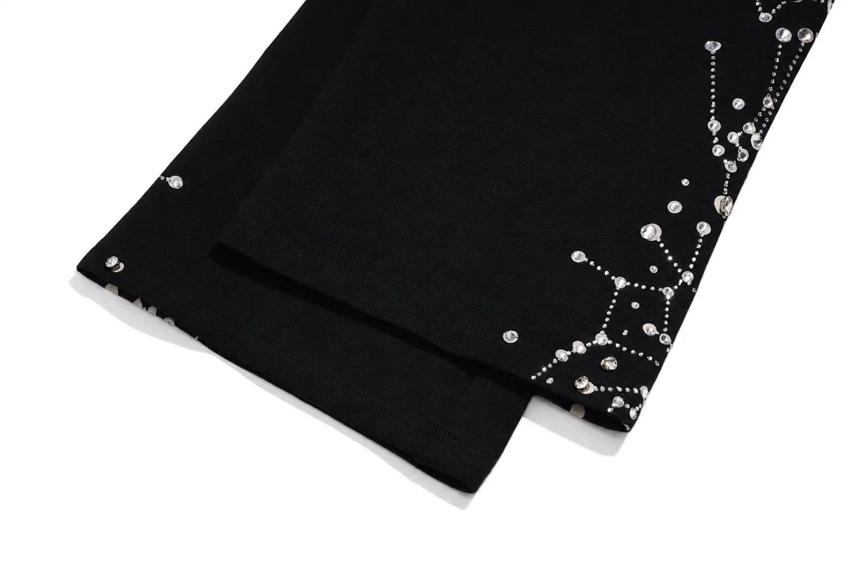 Black fabric trim or sleeve lining with silver rhinestone embellishments along one edge, shown folded on a white background. TCH Rhinestone Constellation Straight-Leg Sweatpants