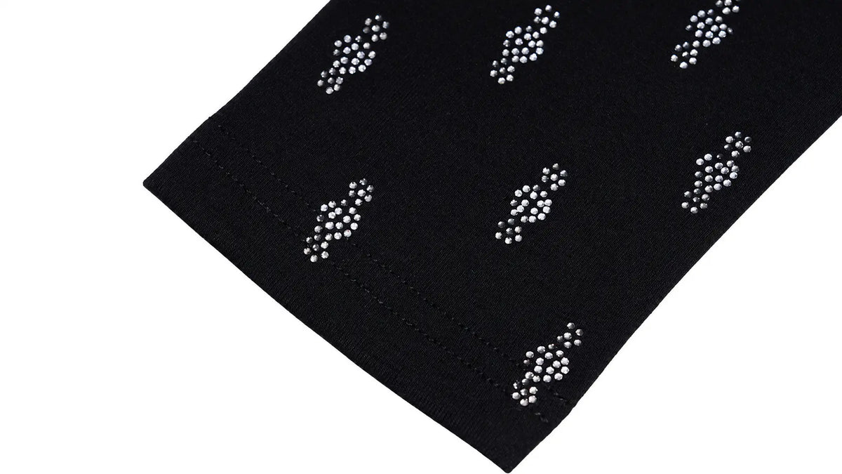 A close-up of a black fabric product, likely a sleeve or cuff, decorated with repeating white rhinestone clusters on a plain white background. TCH Rhinestone Cross Graphic Fitted Long Sleeve Top